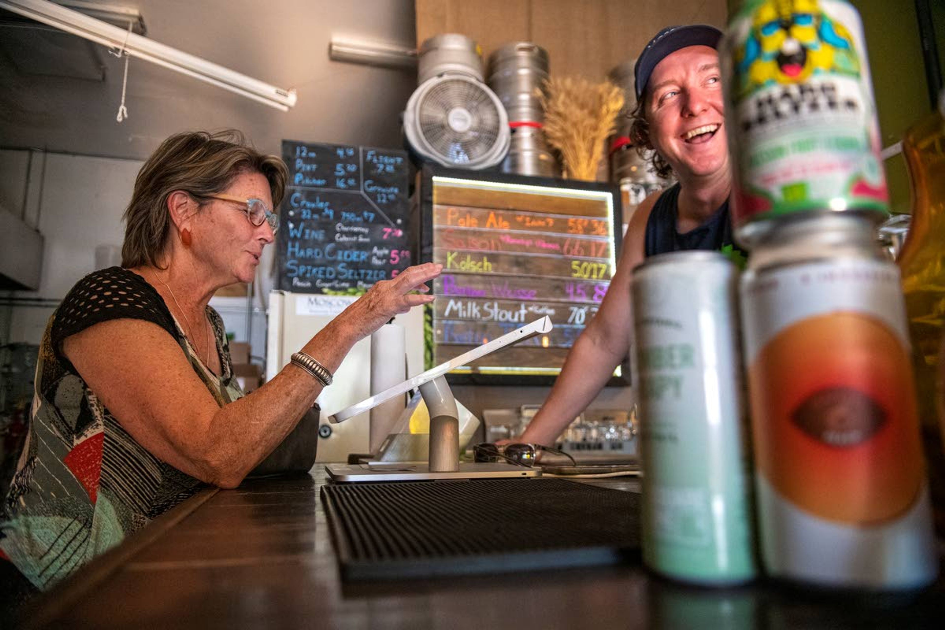 Debby Dane, of Portland, left, jokes with Moscow Brewing Company owner Aaron Hart while purchasing a few drinks on Wednesday evening.