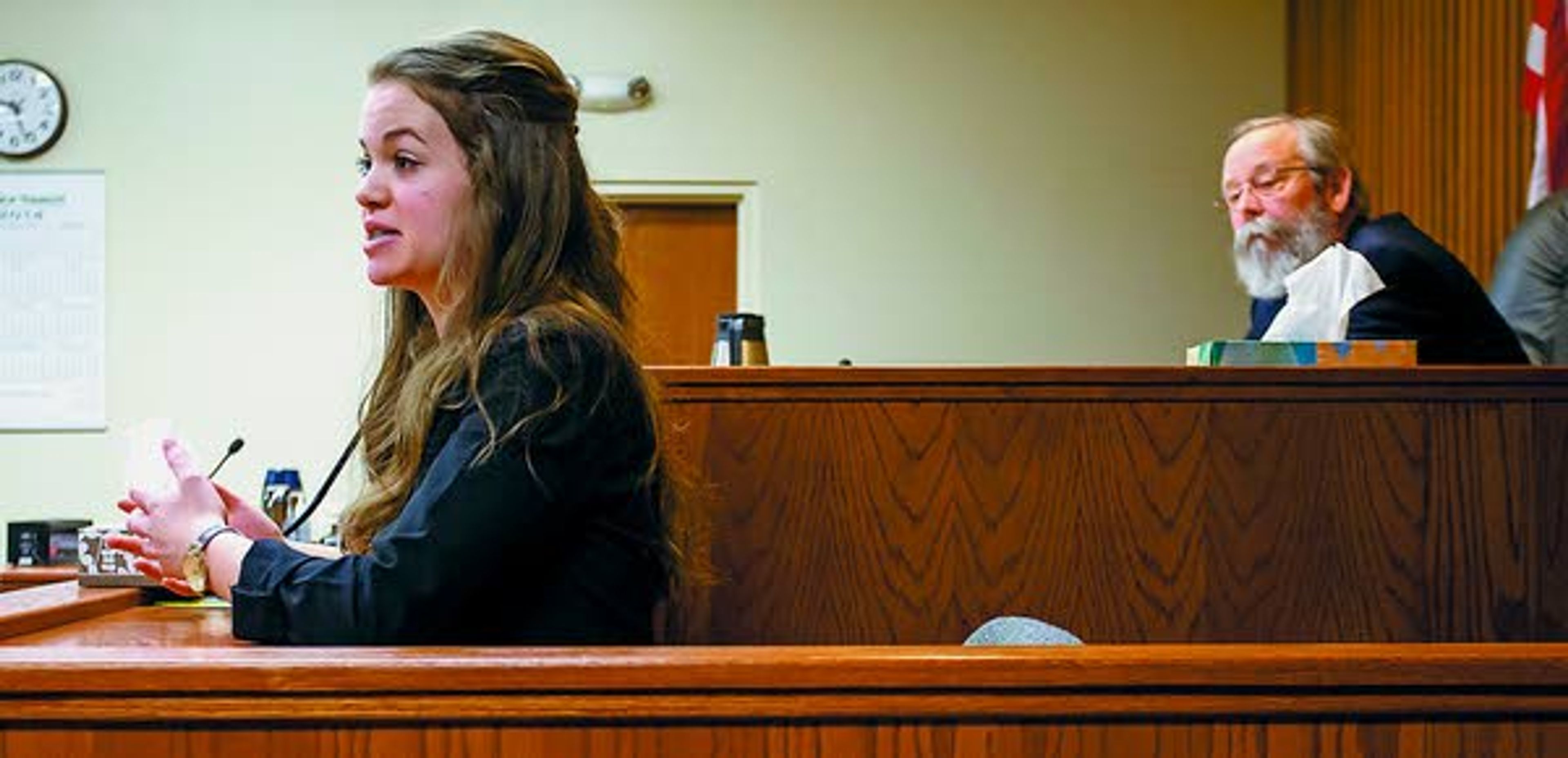 Current student Sofia Minudri, left, playing witness Tracey German, gives evidence as Latah County prosecutor Bill Thompson, right, acting as the judge during the scrimmage, listens during a Logos School mock trial team scrimmage against a group of mock trial alumni as on Saturday, Feb. 22, 2014, at the Latah County Courthouse.