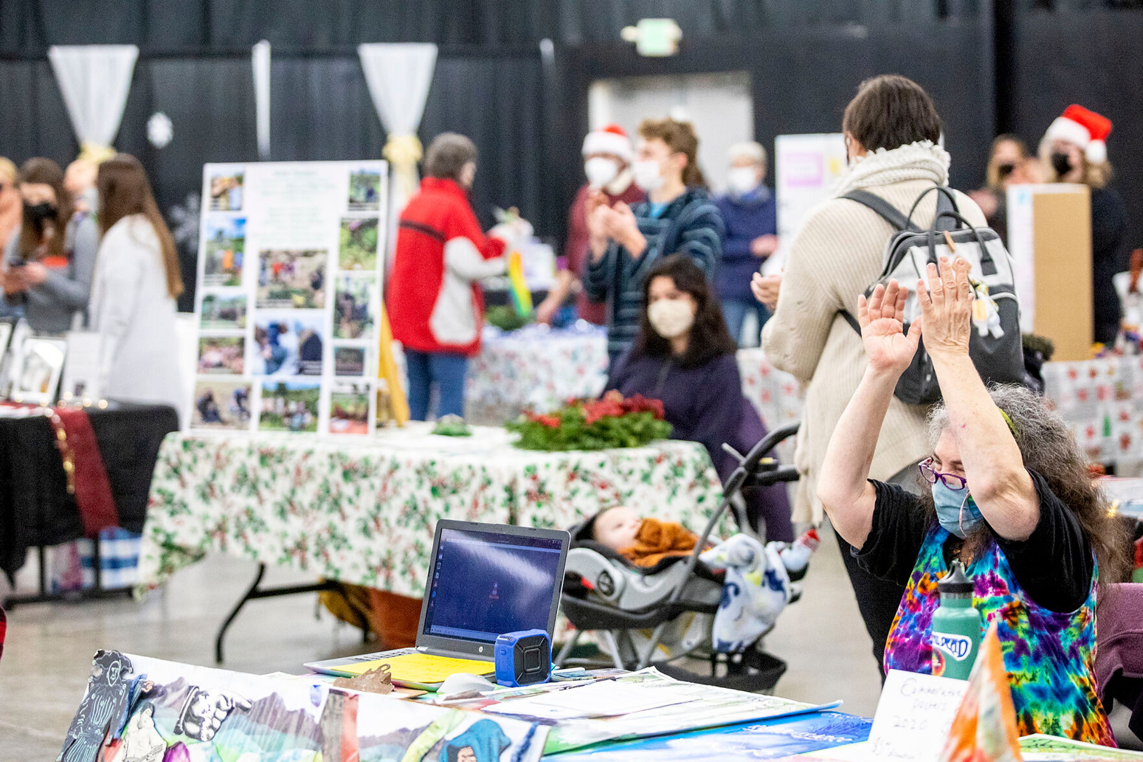 Arlene Falcon claps as the amount raised for non-profits so far is announced ruing the Alternative Giving Market in Moscow on Saturday.