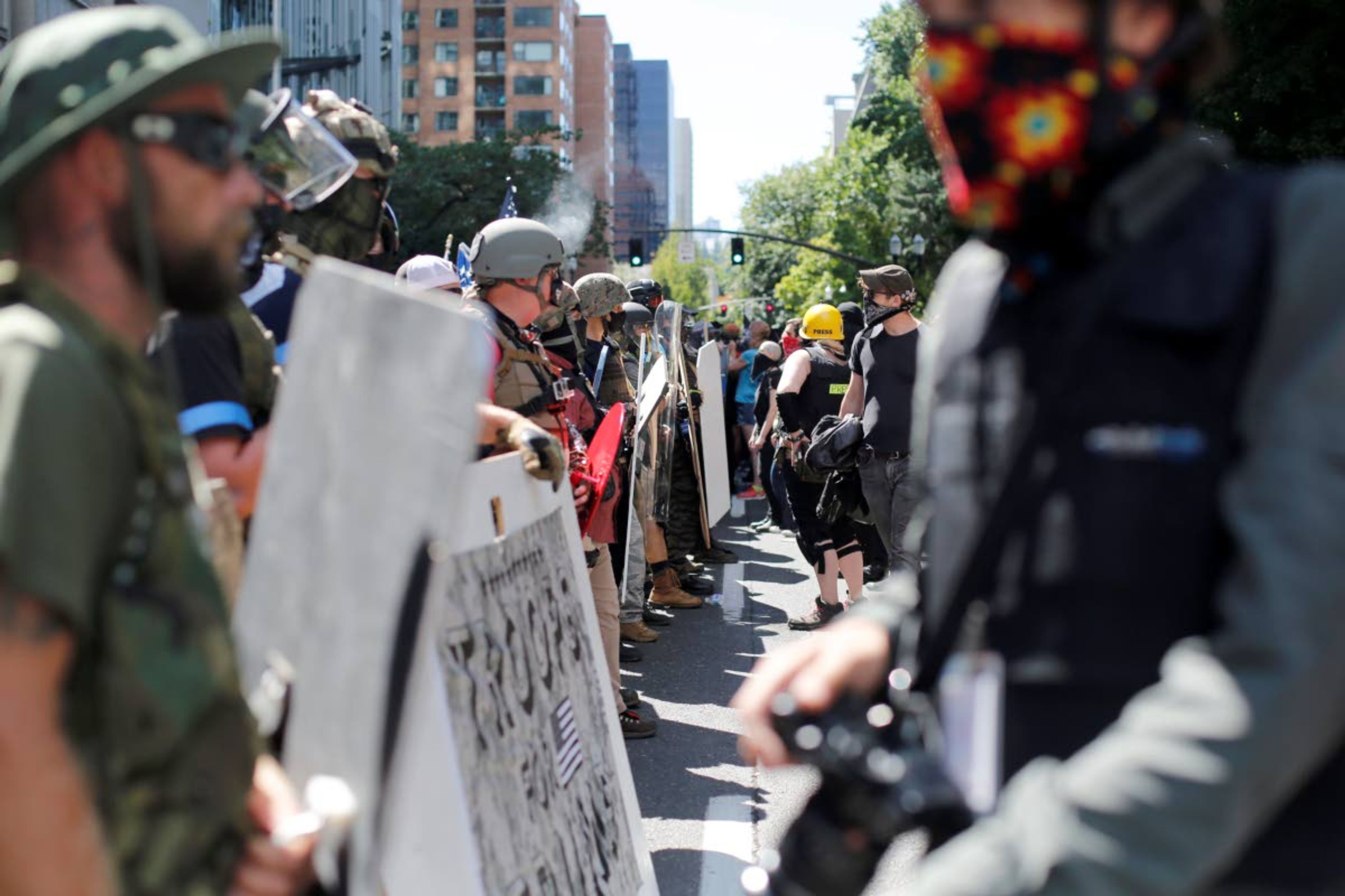 Opposing rallies battle with mace, paint balls and rocks near Justice Center in downtown Portland Saturday, August 22, 2020. Dueling demonstrations in Portland by right-wing and left-wing protesters have turned violent near a county building that's been the site of numerous recent protests. (Brooke Herbert/The Oregonian via AP)/The Oregonian via AP)/The Oregonian via AP)/The Oregonian via AP)