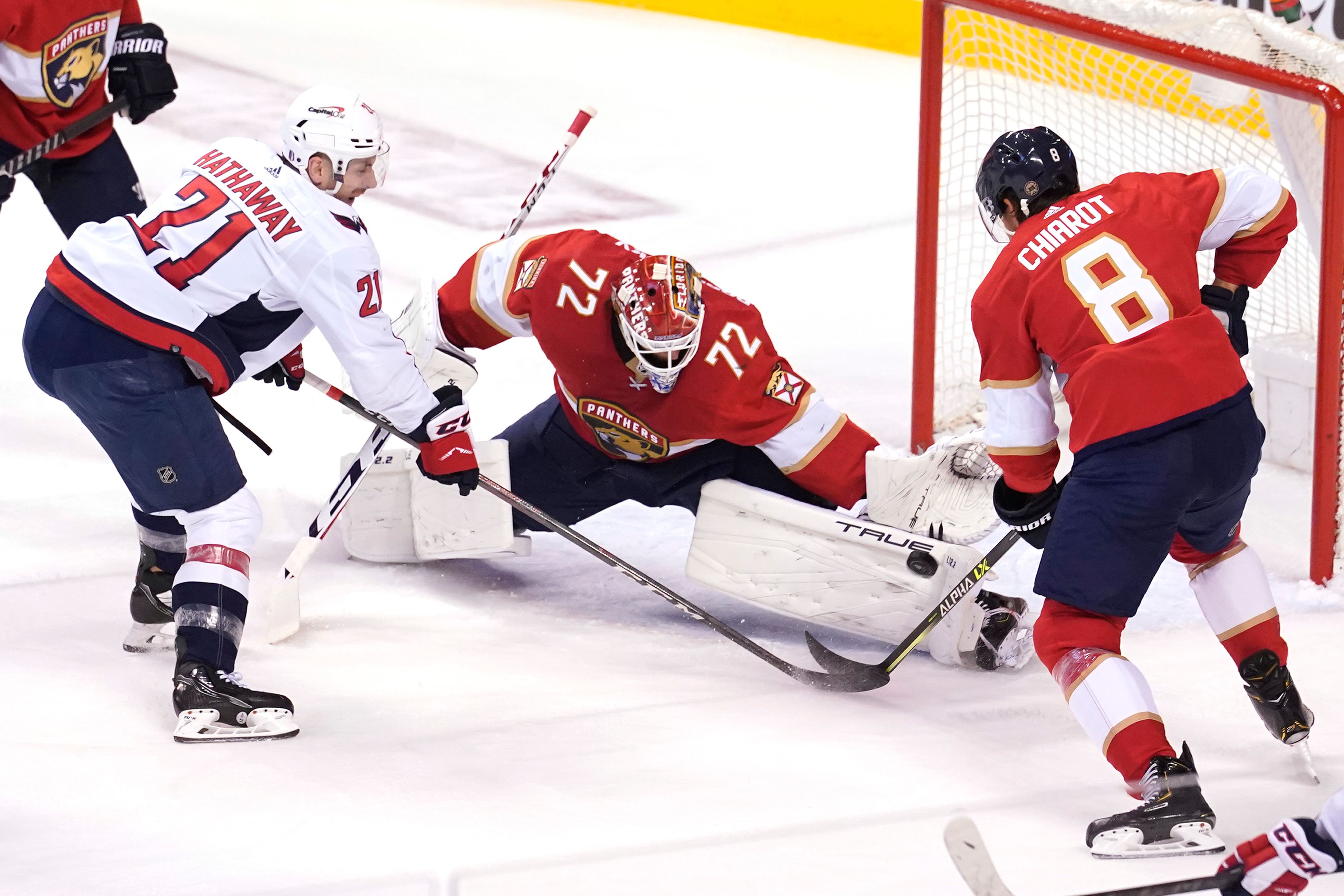 Florida Panthers goaltender Sergei Bobrovsky (72) stops a shot on goal by Washington Capitals right wing Garnet Hathaway (21) as defenseman Ben Chiarot (8) defends during the first period of Game 2 of an NHL hockey first-round playoff series , Thursday, May 5, 2022, in Sunrise, Fla. (AP Photo/Marta Lavandier)