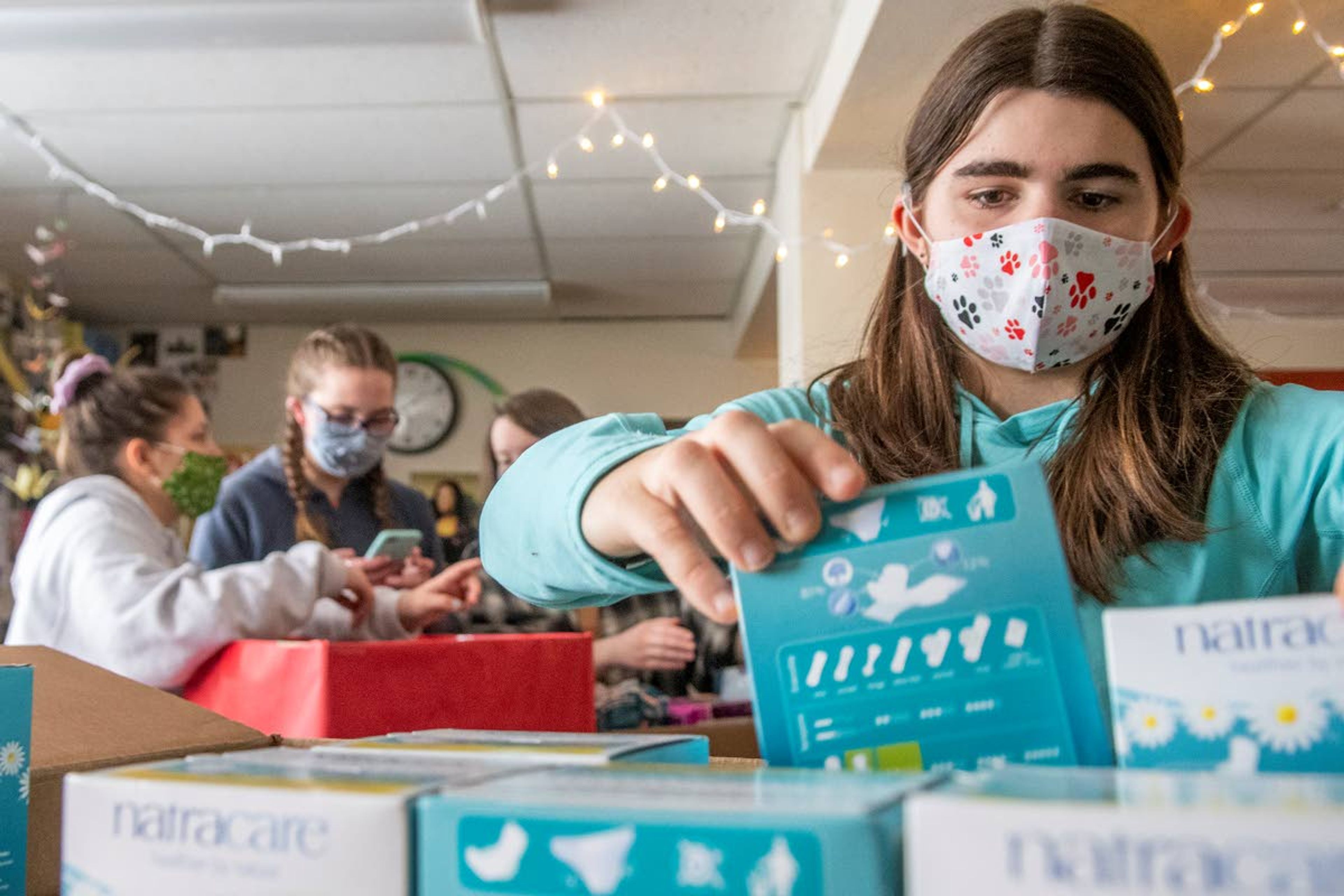 Elle Benson, a junior at Moscow High School, and member of “PERIOD: The Menstrual Movement,” sorts through period product supplies that will be donated to Family Promise of the Palouse and Alternatives to Violence of the Palouse on Wednesday afternoon.