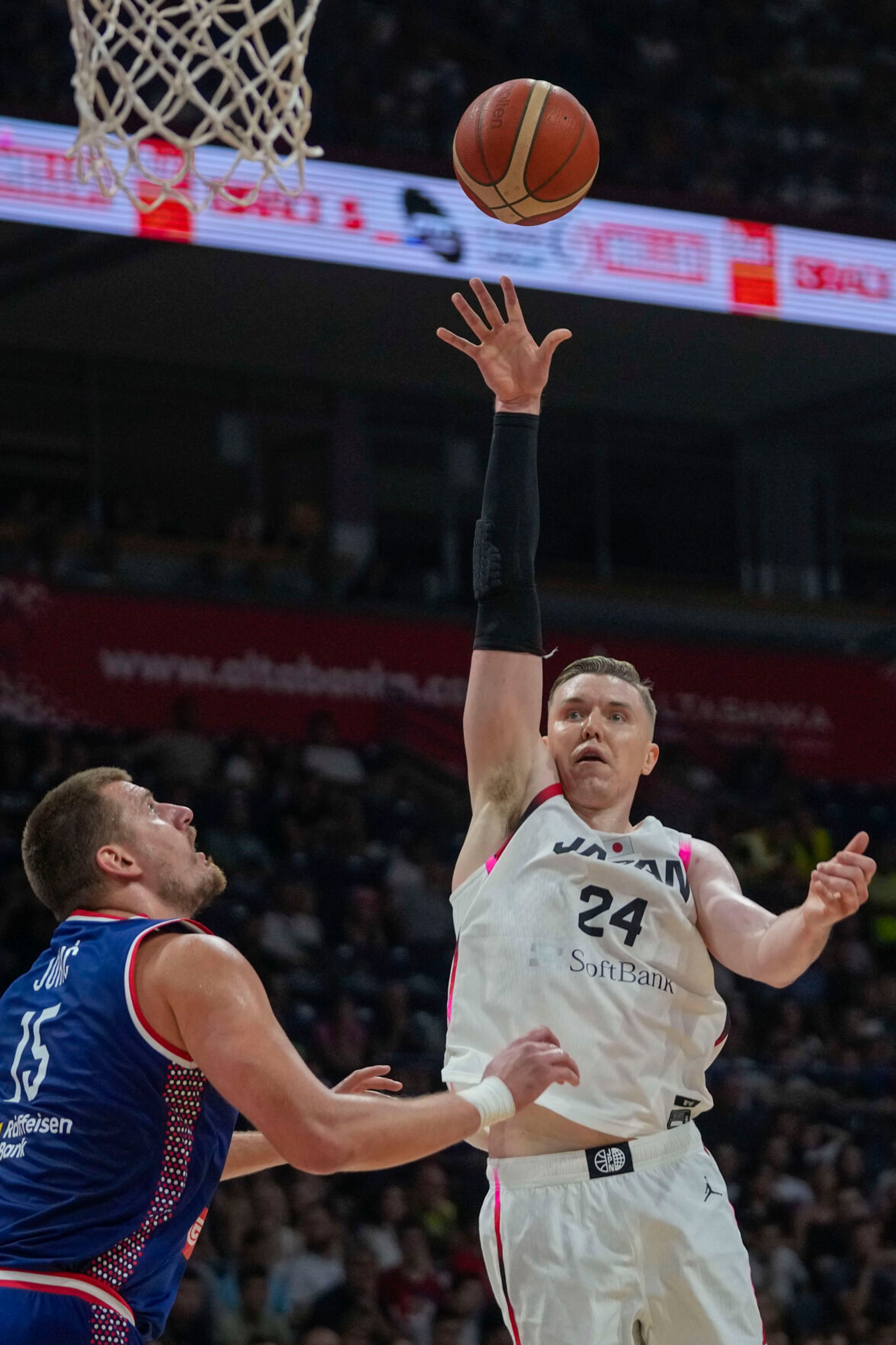 Japan's Josh Hawkinson, right, of Washington State, tries to score as Serbia's Nikola Jokic blocks him during a friendly basketball match between Serbia and Japan, Sunday, July 21, 2024, in Belgrade, Serbia. (AP Photo/Darko Vojinovic)