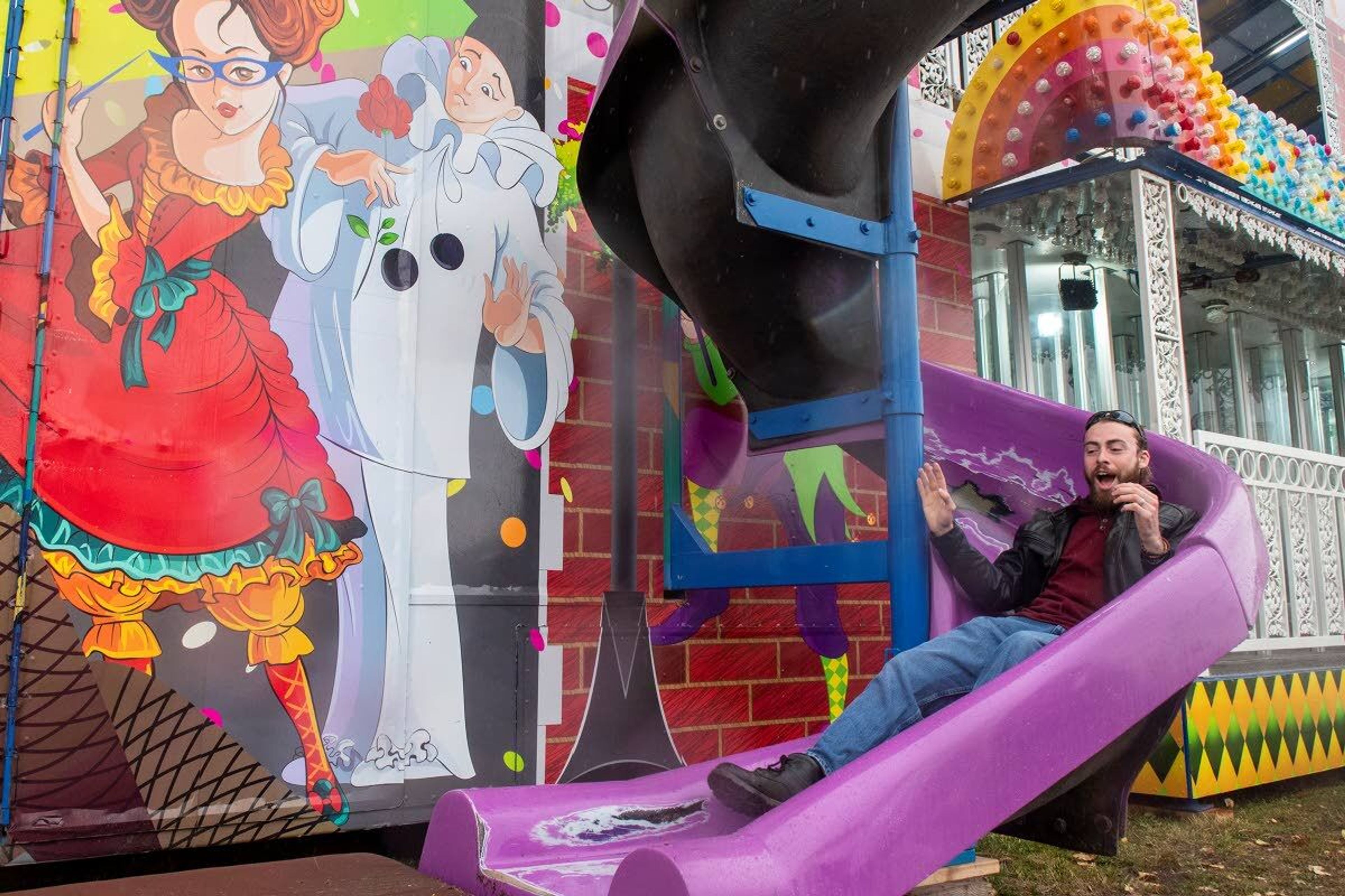 Jerome French, of Moscow, rides down the slide after walking through the house of mirrors at the Latah County Fair on Saturday morning in Moscow.