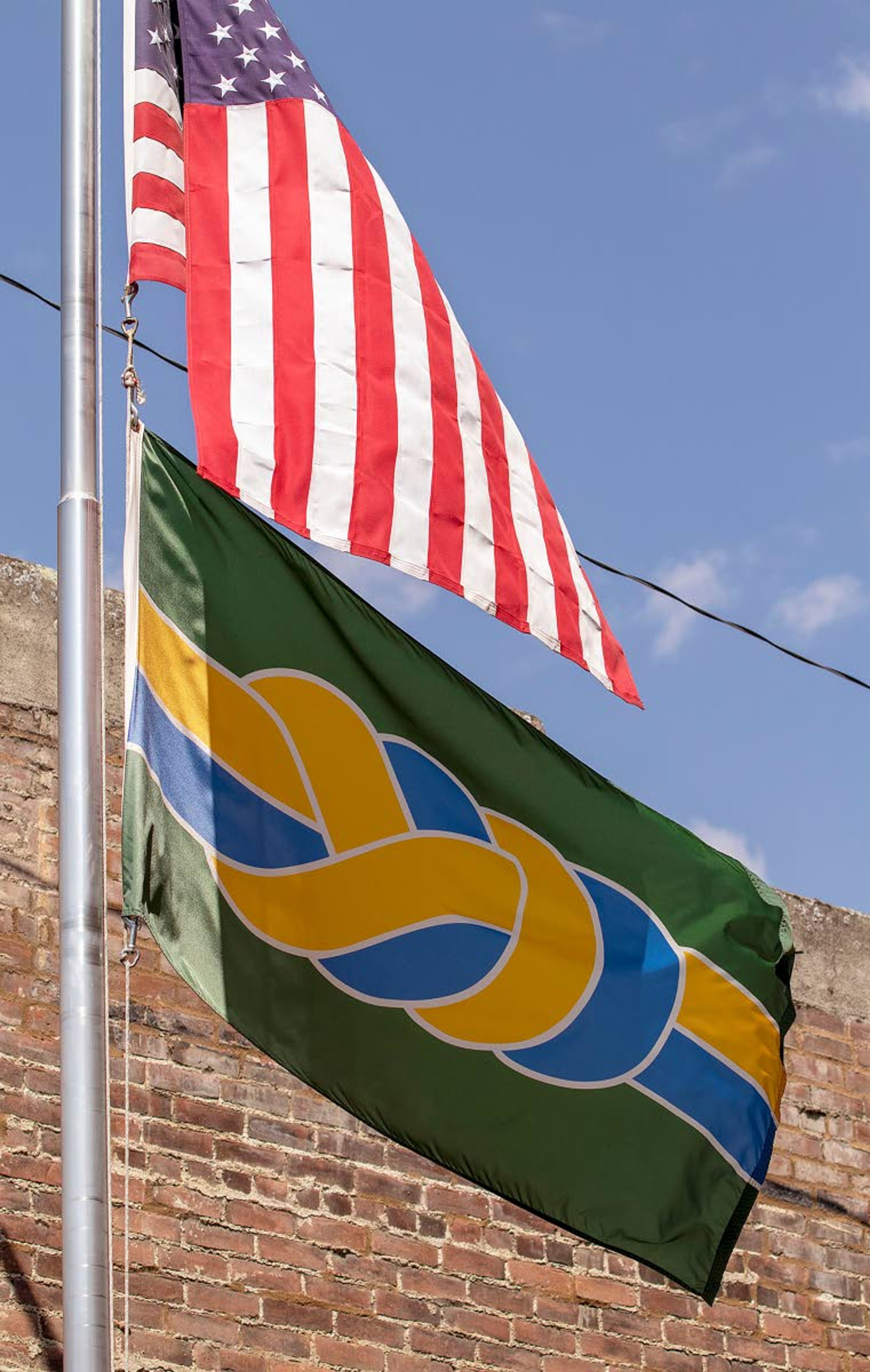 The Palouse city flag flies below the United State flag on Thursday outside city hall in Palouse. The flag was designed by local Palouse resident Moses Boone and adopted in 2019.