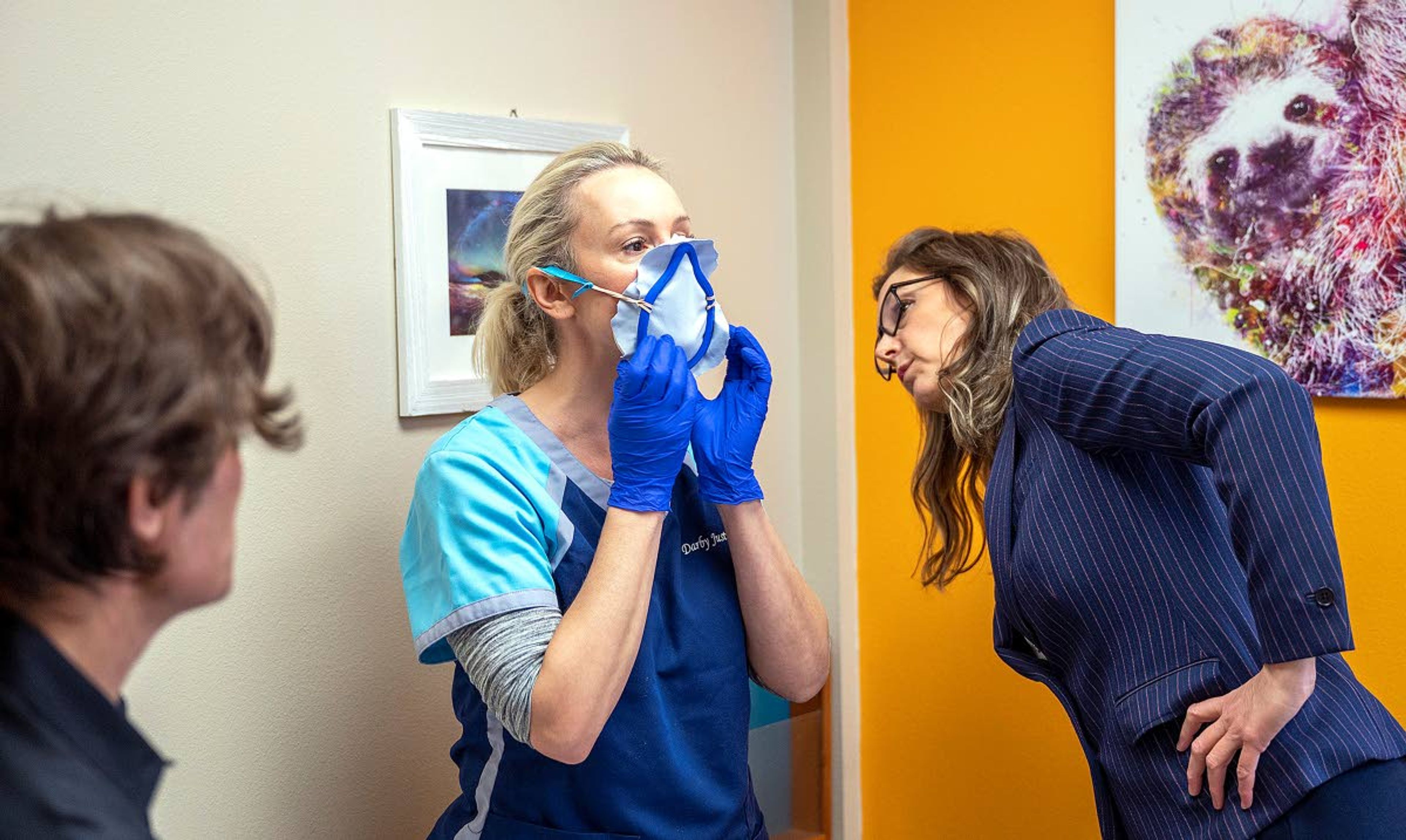 Robin Albers (right), the area rehab director for Infinity Rehab, and Natale Carasali (left), a doctor at Valley Medical Center, looks on as Darby Justis tries on an experimental mask that was provided by the University of Idaho School of Engineering on Wednesday at Valley Medical Center in Lewiston. Justis was trying on the prototype perimeter mask.