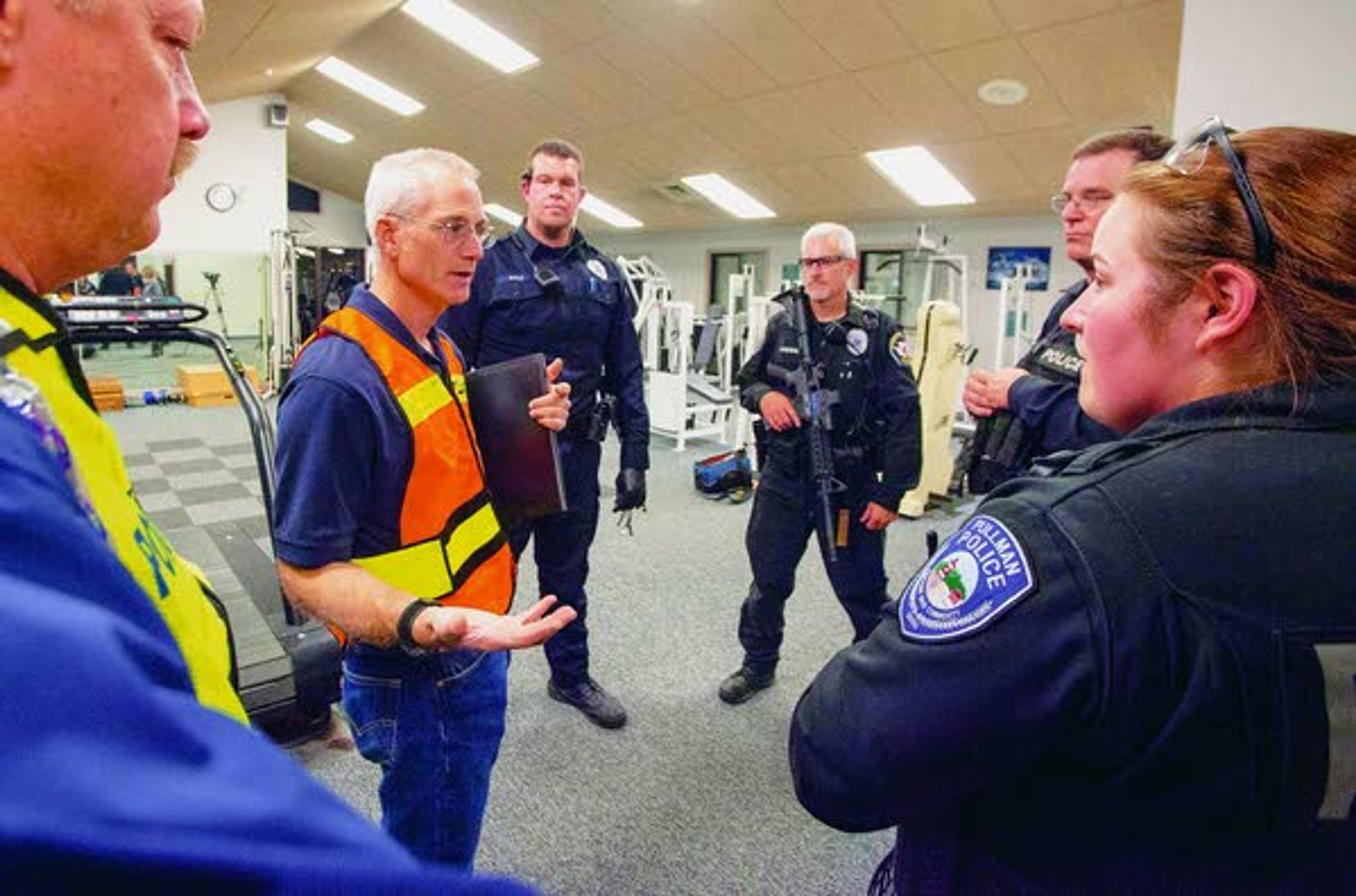 Pullman Police Cmdr. Chris Tennant, second from left, conducts and after-action debriefing with officers (right to left) Heidi Lambly, Monty Griffin, Jeff Olmstead and Chris Engle as PPD chief Gary Jenkins, far left, listens after an active shooter response drill run by the Pullman Police Department on Sunday at Summit Therapy in Pullman.