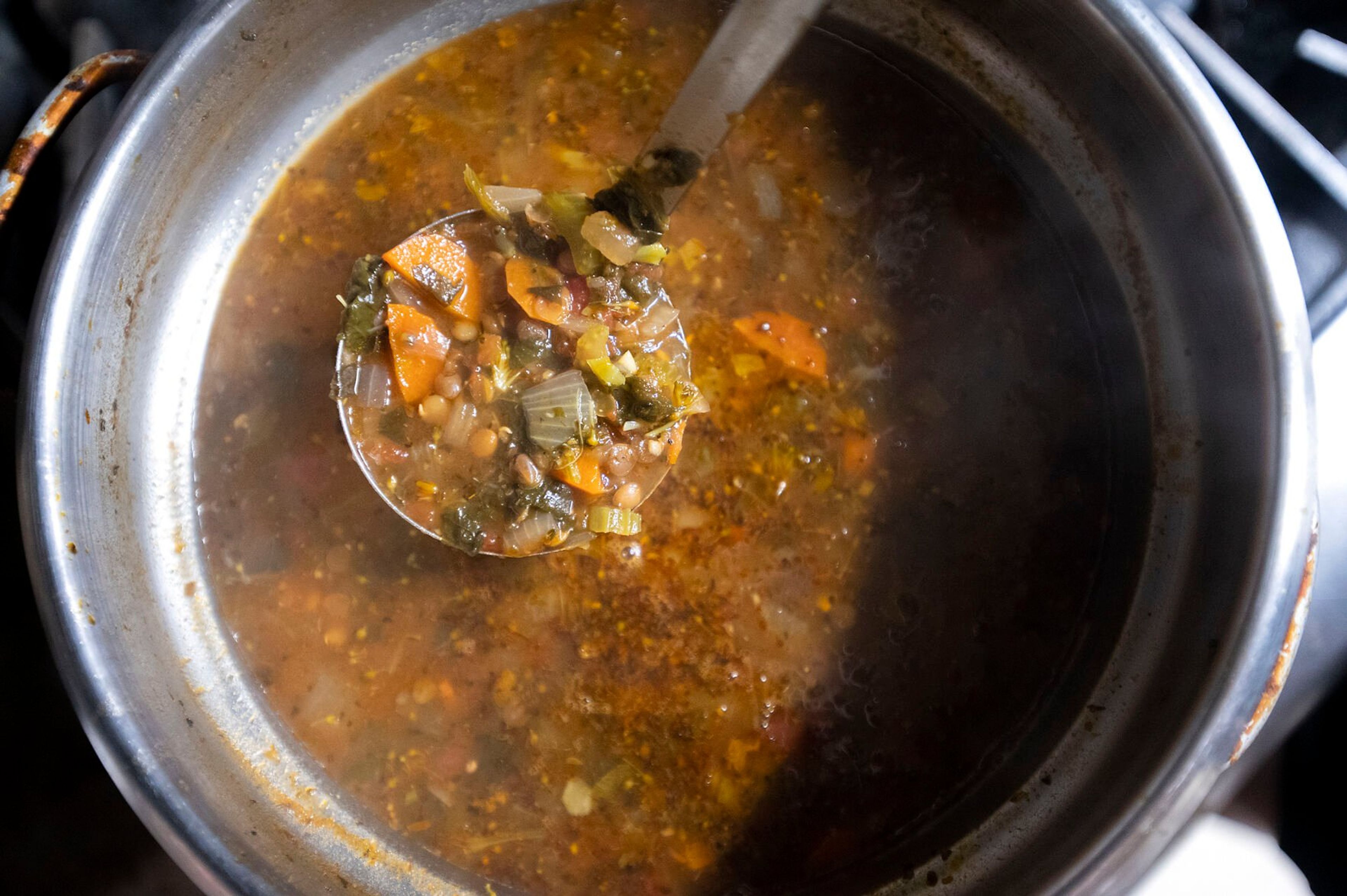 Mina Ashkannejhad stirs a pot of lentil soup at Mikey’s Gyros in Moscow.