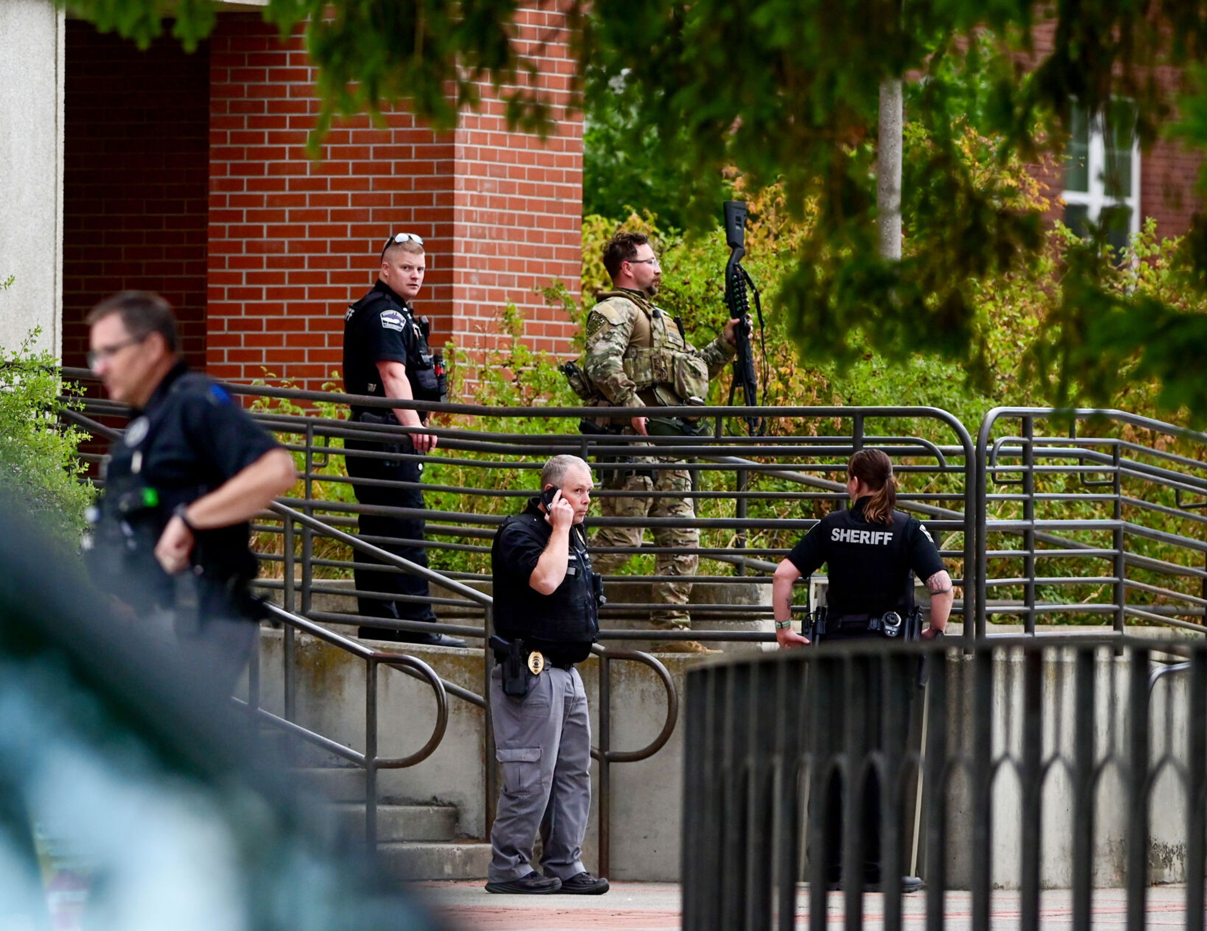 Police move about in front of Theophilus Tower on the University of Idaho campus on Tuesday in Moscow. Officers responded to reports that an inmate walked away from a cleaning crew in the dormitory that afternoon.