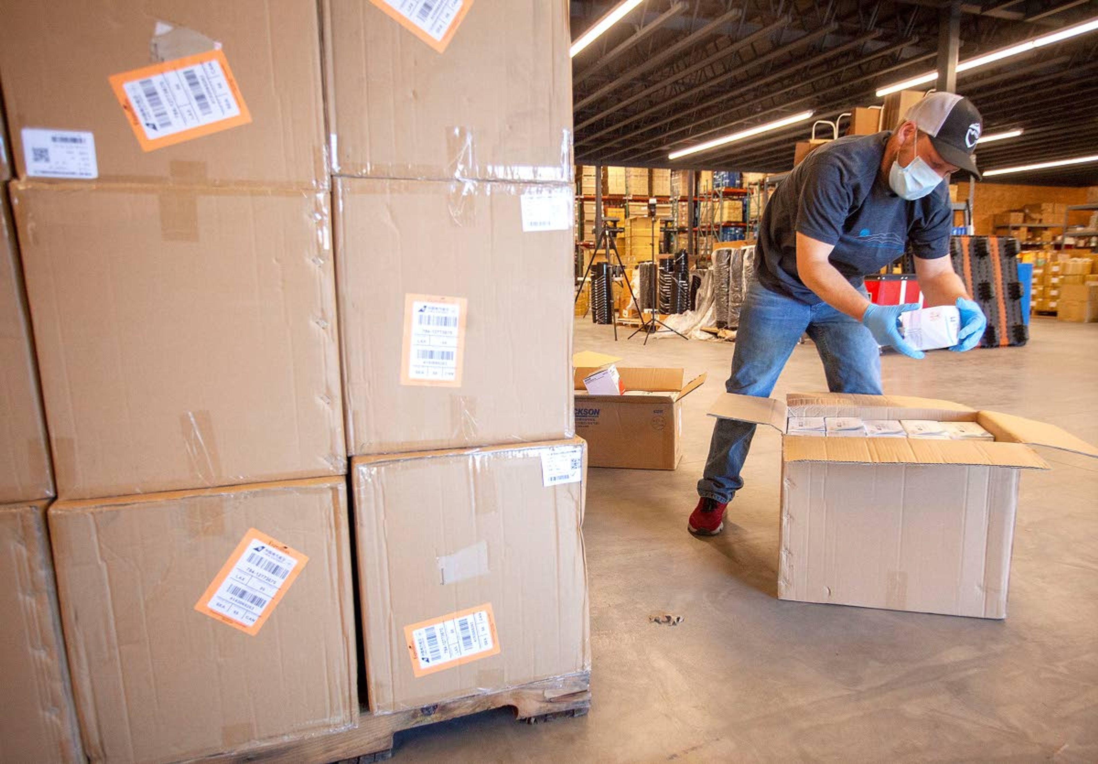 Mike Parsons unpacks a box of disposable protective masks after receiving a sipment of masks, KN95 respirators and latex gloves on Thursday at Northwest River Supplies in Moscow. NRS donated 500 masks each to the Moscow Volunteer Fire Department and the Pullman Fire Department. The remainder of the shipment has been purchased by area hospitals and first responders.