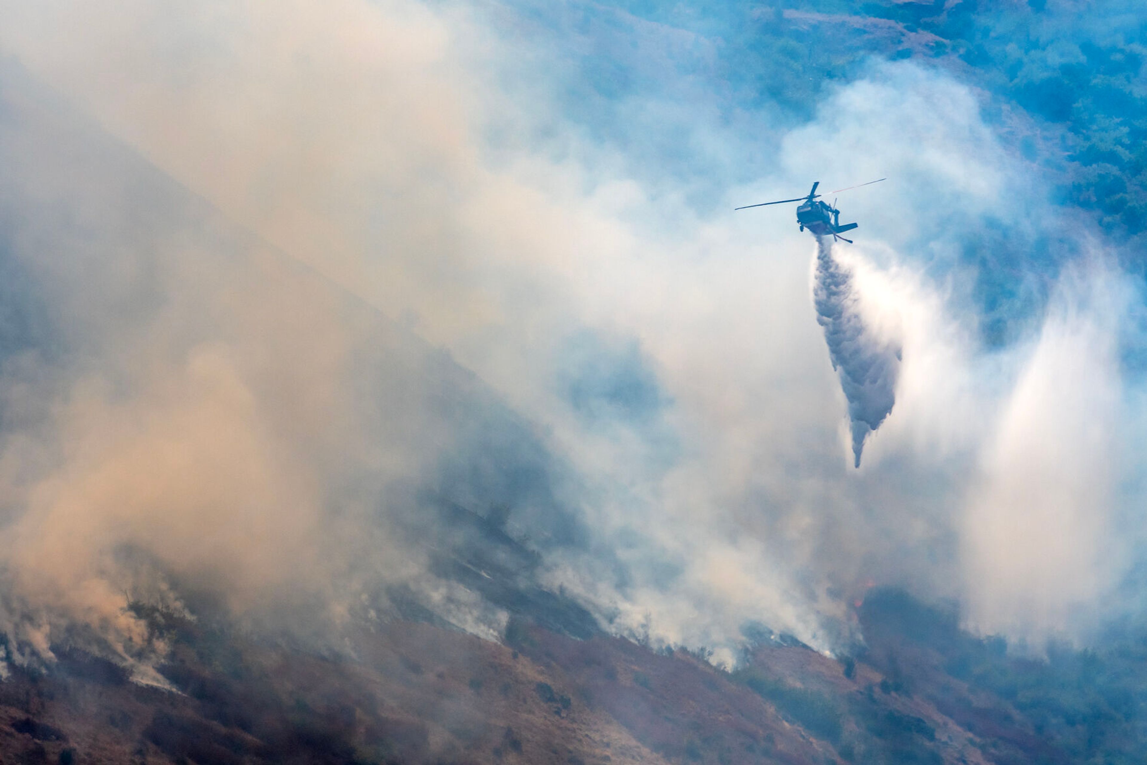 A helicopter makes a drop on the Lower Granite Fire Tuesday off the Snake River.