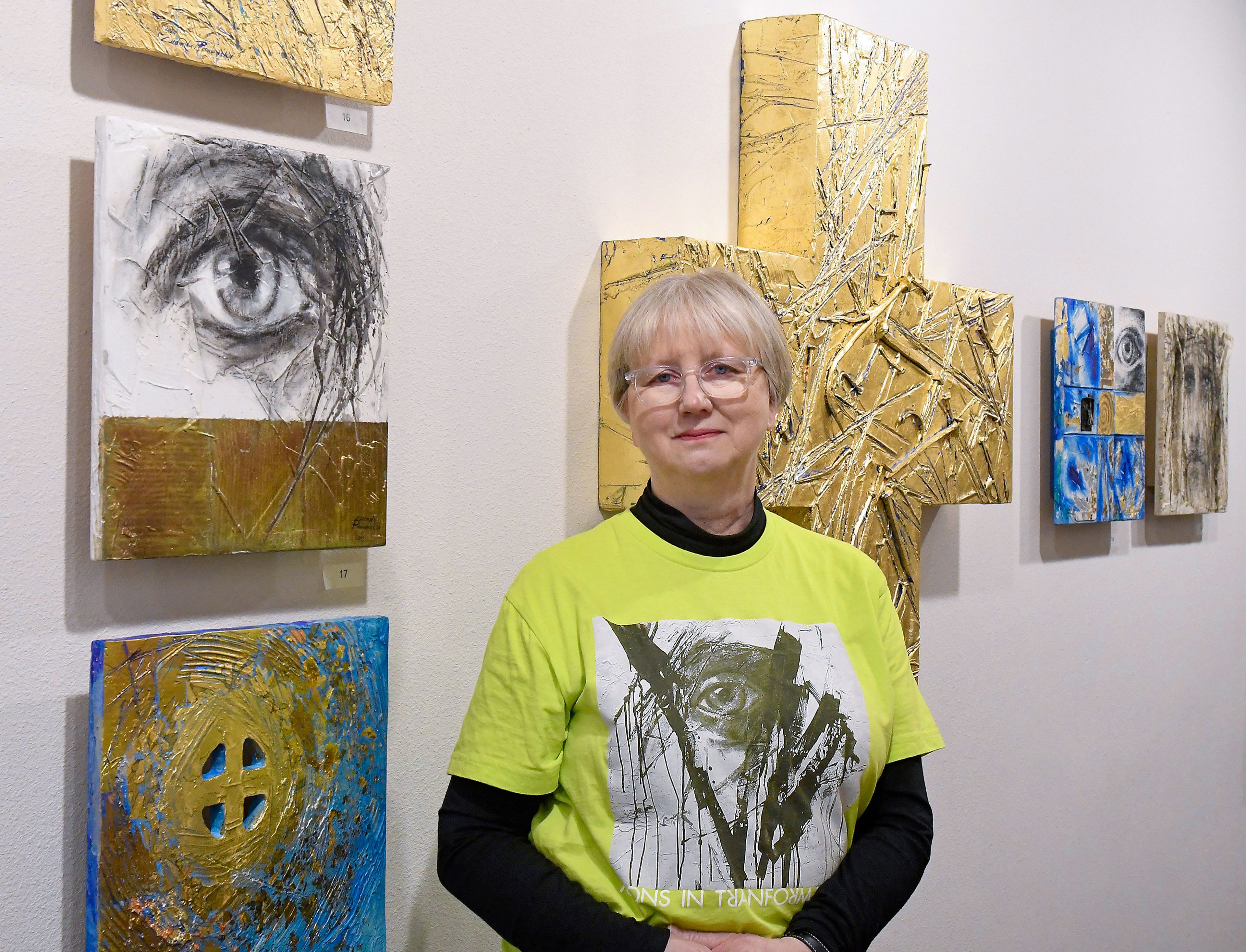 Mary Flores, primary coordinator for Ludmila Pawlowska�s traveling exhibit, �Icons in Transformation,� stands alongside pieces of the exhibit Thursday at St. James Episcopal Church in Pullman.,