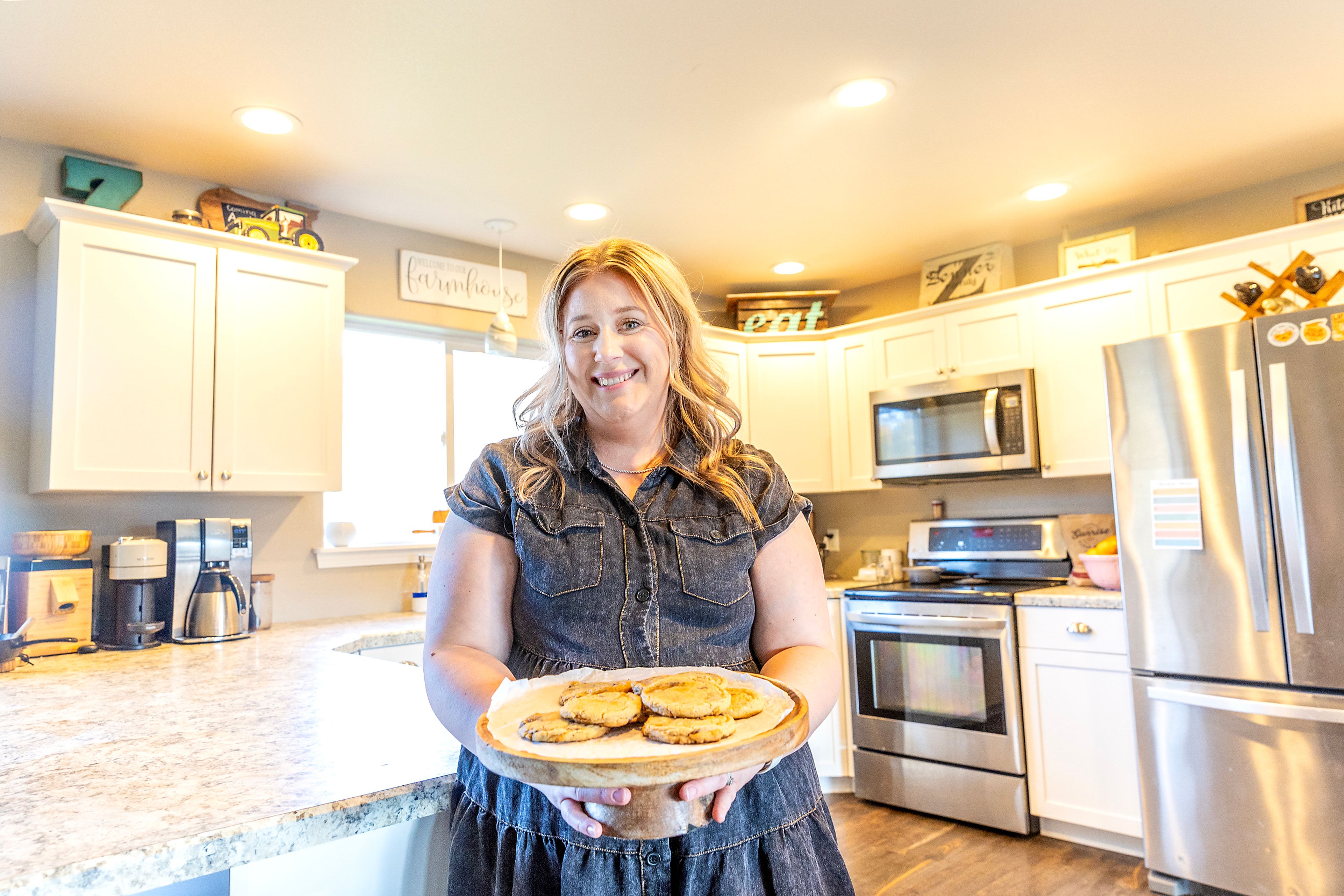 Kayla Zenner holds a tray of cookies at her home.