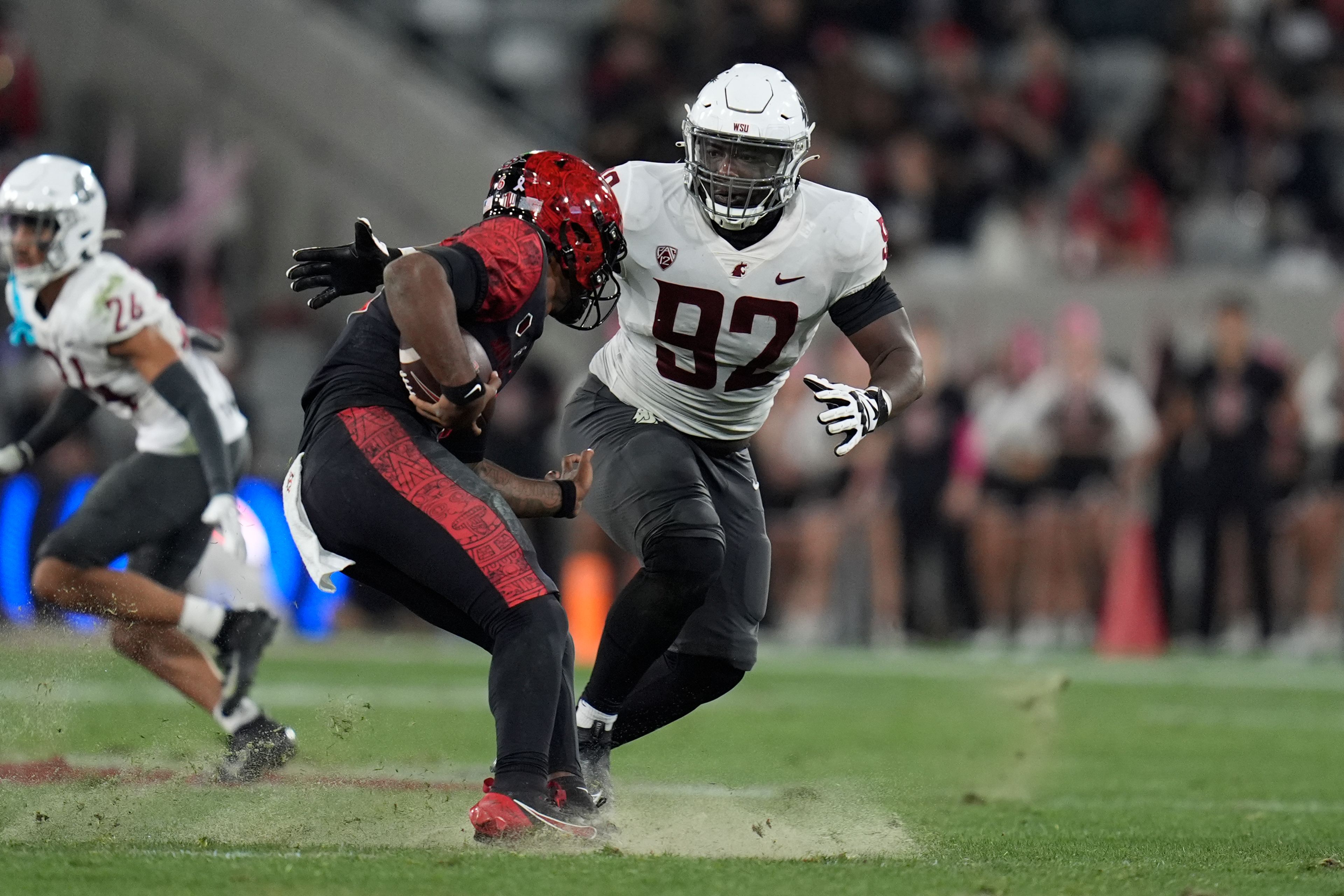 Washington State defensive lineman Ansel Din-Mbuh stops San Diego State quarterback Javance Tupou'ata-Johnson during the first half of an NCAA college football game Saturday, Oct. 26, 2024, in San Diego. (AP Photo/Gregory Bull)