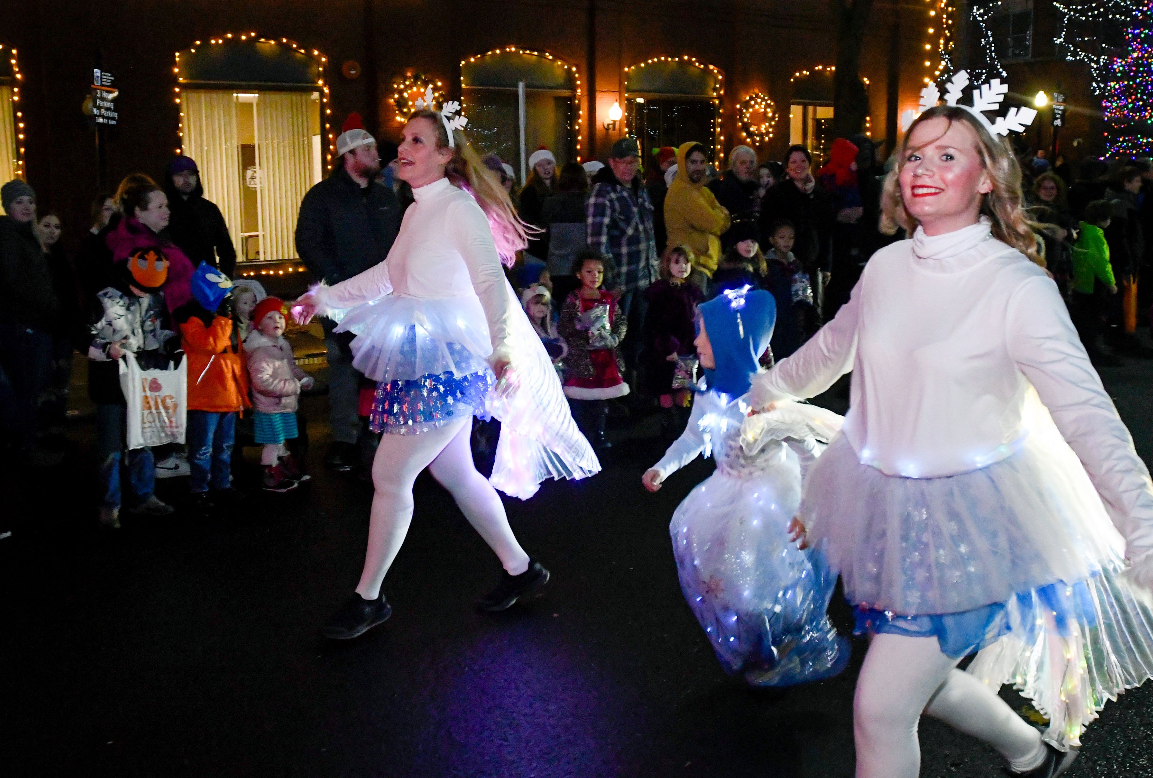 Dancers make their way down Main Street as part of the Light Up the Season parade on Thursday.