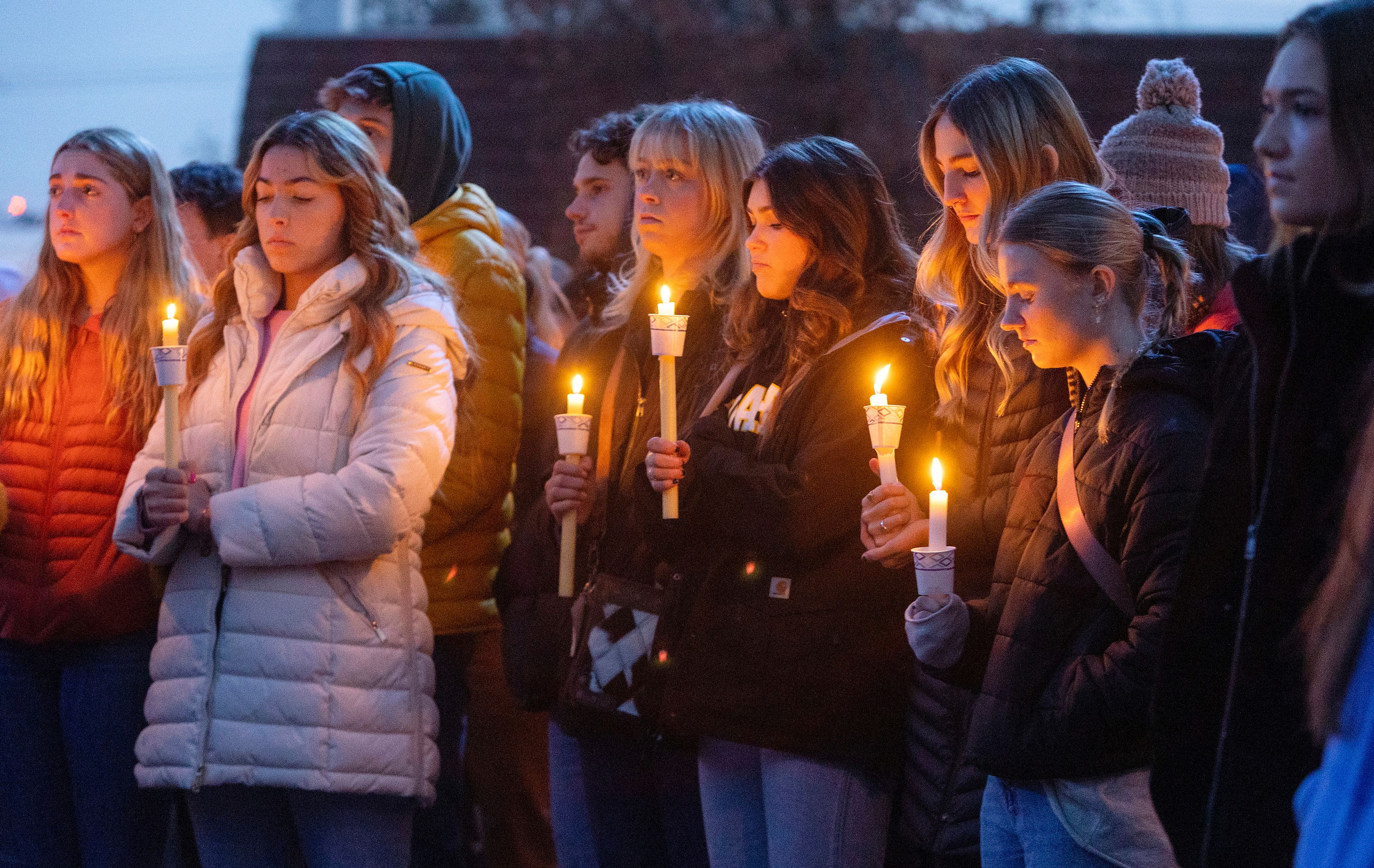 FILE - Boise State University students, along with people who knew the four University of Idaho students who were found killed in Moscow, Idaho, days earlier, pay their respects at a vigil held in front of a statue on the Boise State campus, Thursday, Nov. 17, 2022, in Boise, Idaho. Investigators have yet to name a suspect in the stabbing deaths of four University of Idaho students who were found dead in a home near campus last month. But would-be armchair detectives and internet sleuths have come up with several of their own, the conclusions often based on conjecture and rumor. (Sarah A. Miller/Idaho Statesman via AP, File)