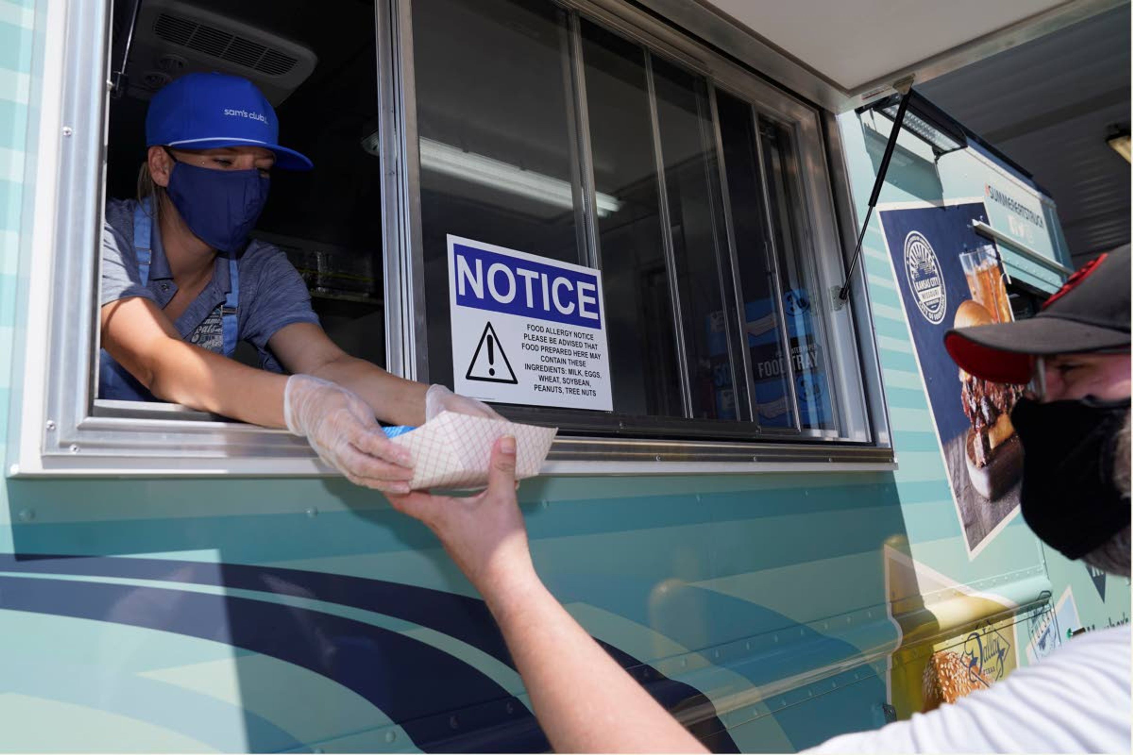 Tiffany Sawczenko hands a a food sample to a man that identified himself as Zeiis Friday, June 18, 2021, in McKinney, Texas. When the pandemic was declared in March 2020, retailers worried about the potential spread of the coronavirus so they cut off free sampling of everything from food to makeup to toys. But now with vaccinations rolling out and the threat of COVID-19 easing in the U.S., food vendors and stores are feeling confident enough to revive the longstanding tradition.(AP Photo/LM Otero)