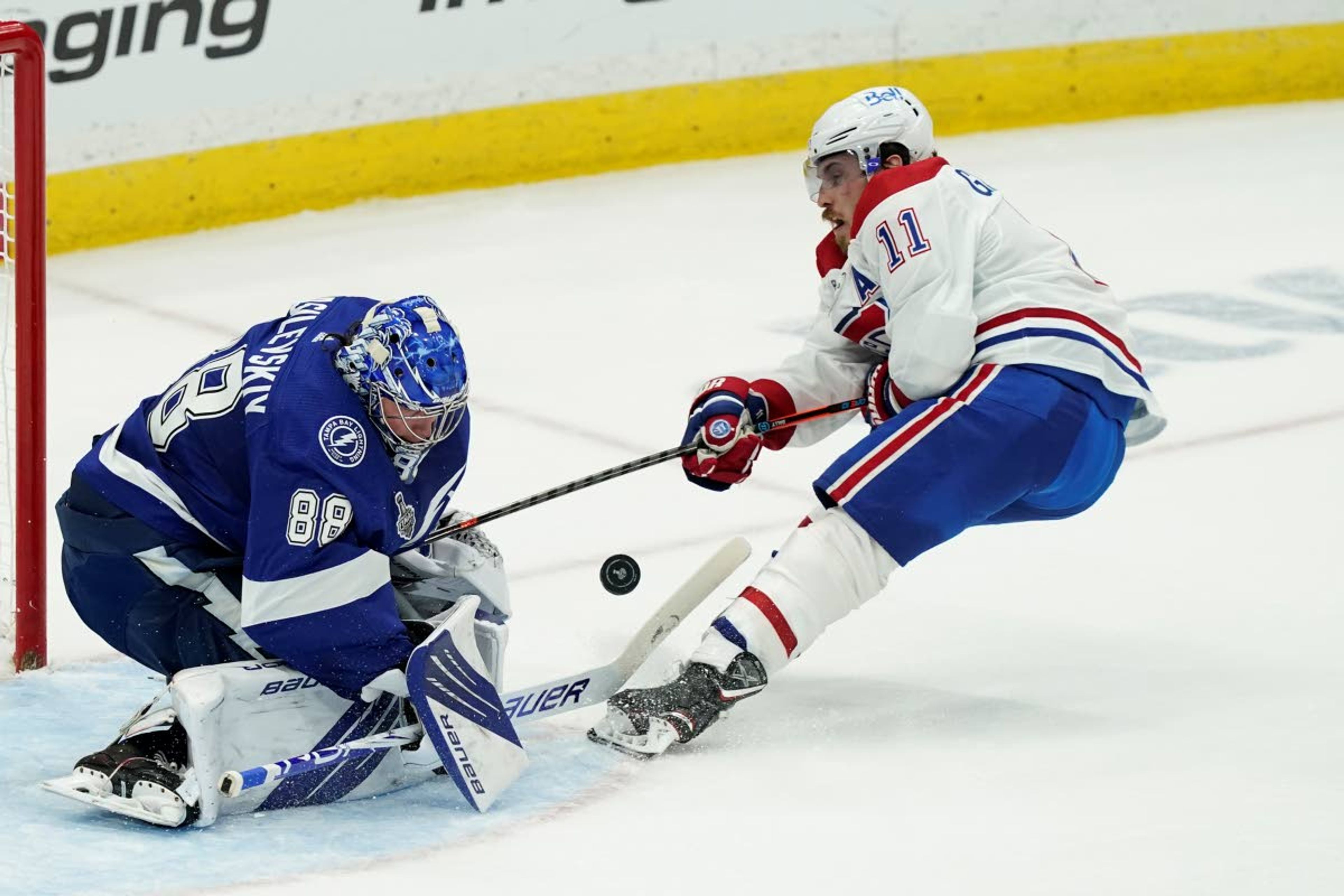 Tampa Bay Lightning goaltender Andrei Vasilevskiy (88) blocks a shot by Montreal Canadiens right wing Brendan Gallagher (11) during the second period in Game 1 of the NHL hockey Stanley Cup finals, Monday, June 28, 2021, in Tampa, Fla. (AP Photo/Gerry Broome)