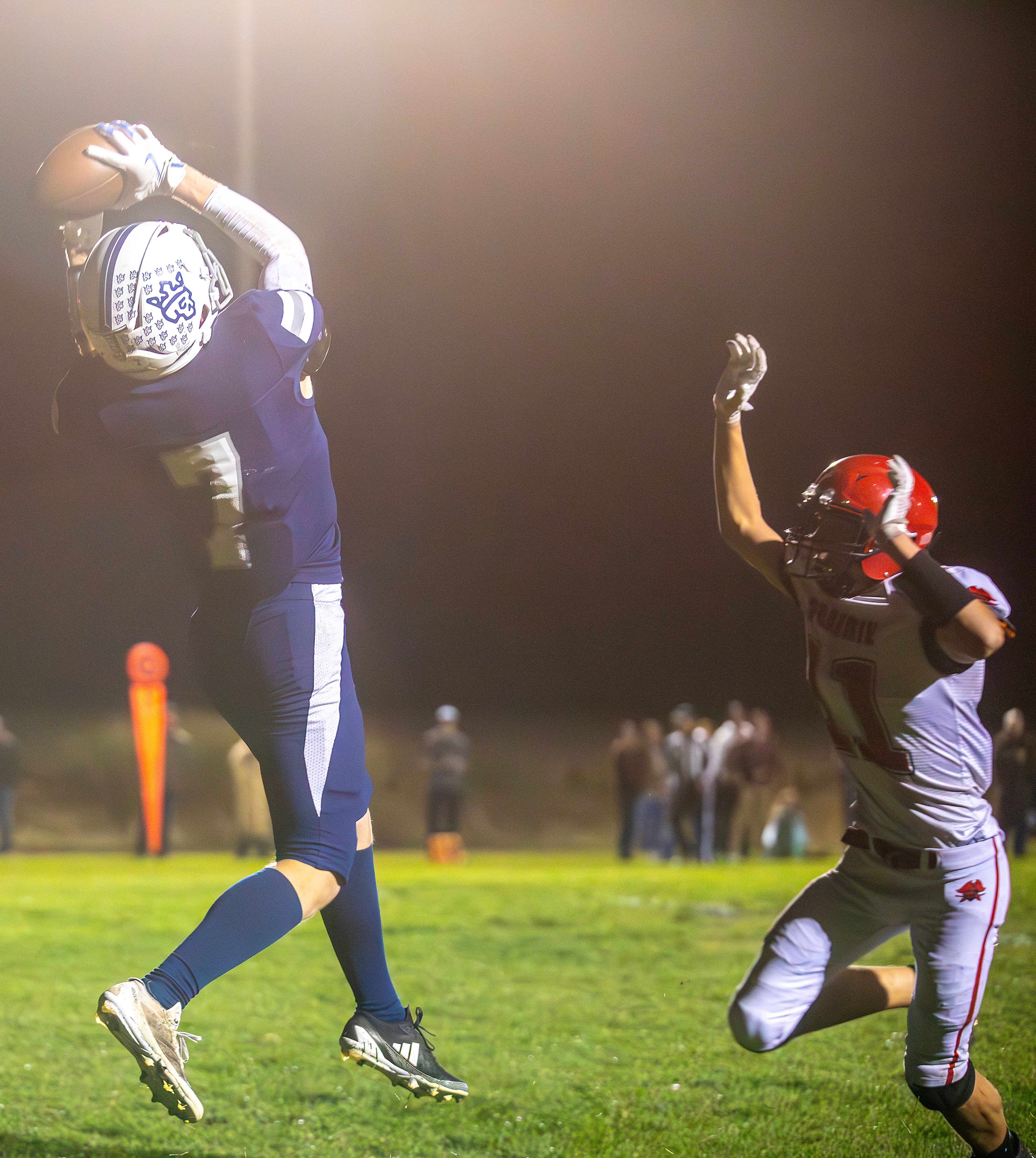 Logos Jonathan Grauke makes a catch for a touchdown as Prairie Briggs Rambo looks on during a conference game Friday in Moscow.,