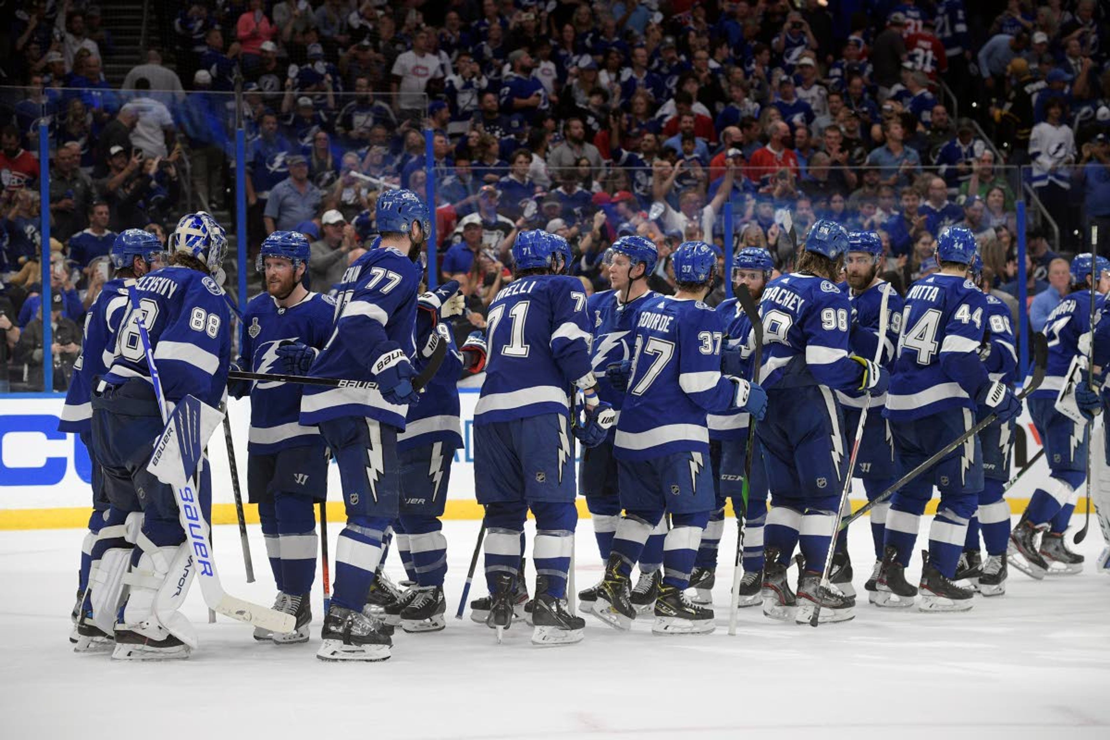 Tampa Bay Lightning players celebrate after the third period in Game 1 of the NHL hockey Stanley Cup finals against the Montreal Canadiens, Monday, June 28, 2021, in Tampa, Fla. The Lightning won 5-1. (AP Photo/Phelan Ebenhack)