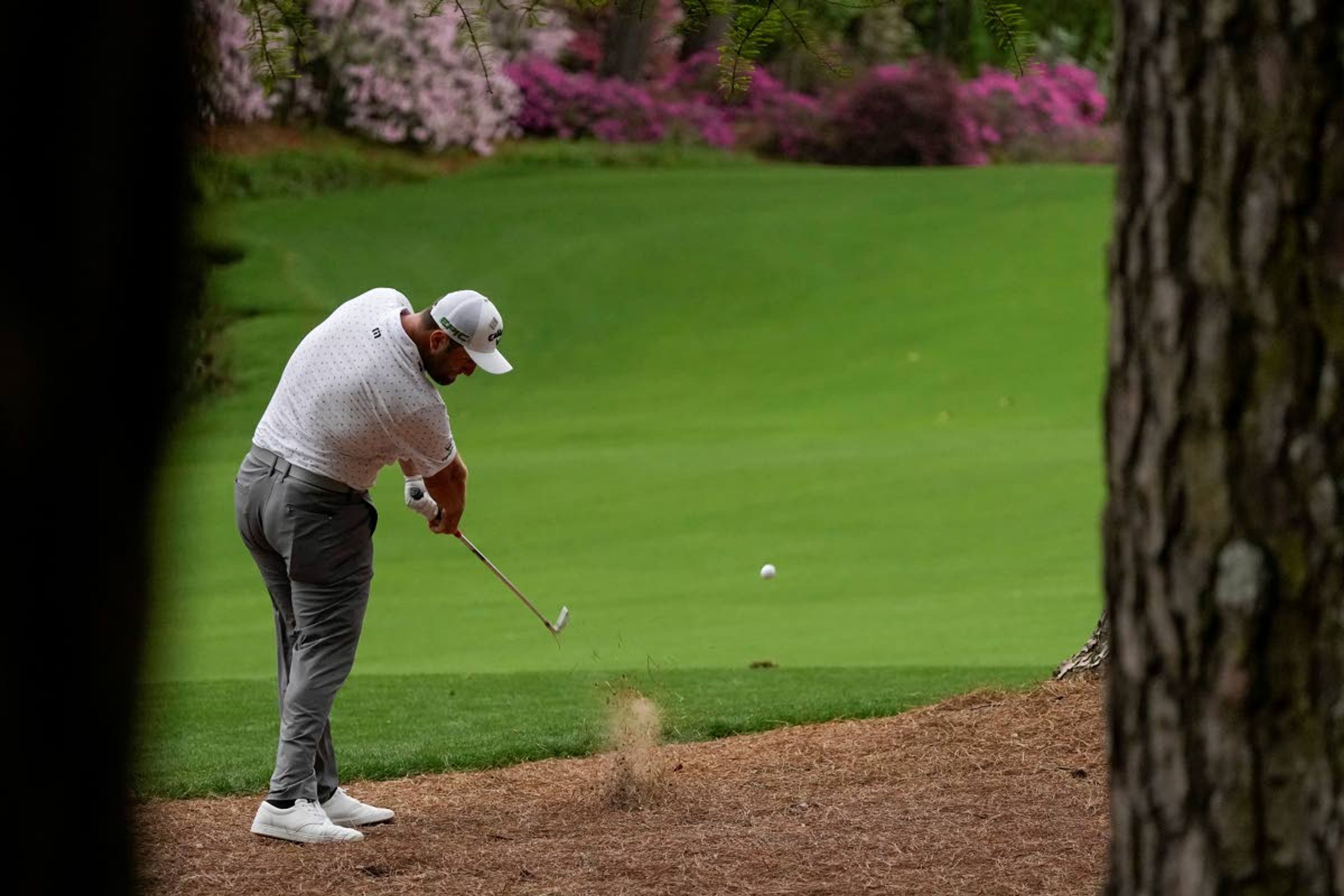 Jon Rahm, of Spain, hits out of the pine straw on the 13th hole during the second round of the Masters golf tournament on Friday, April 9, 2021, in Augusta, Ga. (AP Photo/Charlie Riedel)