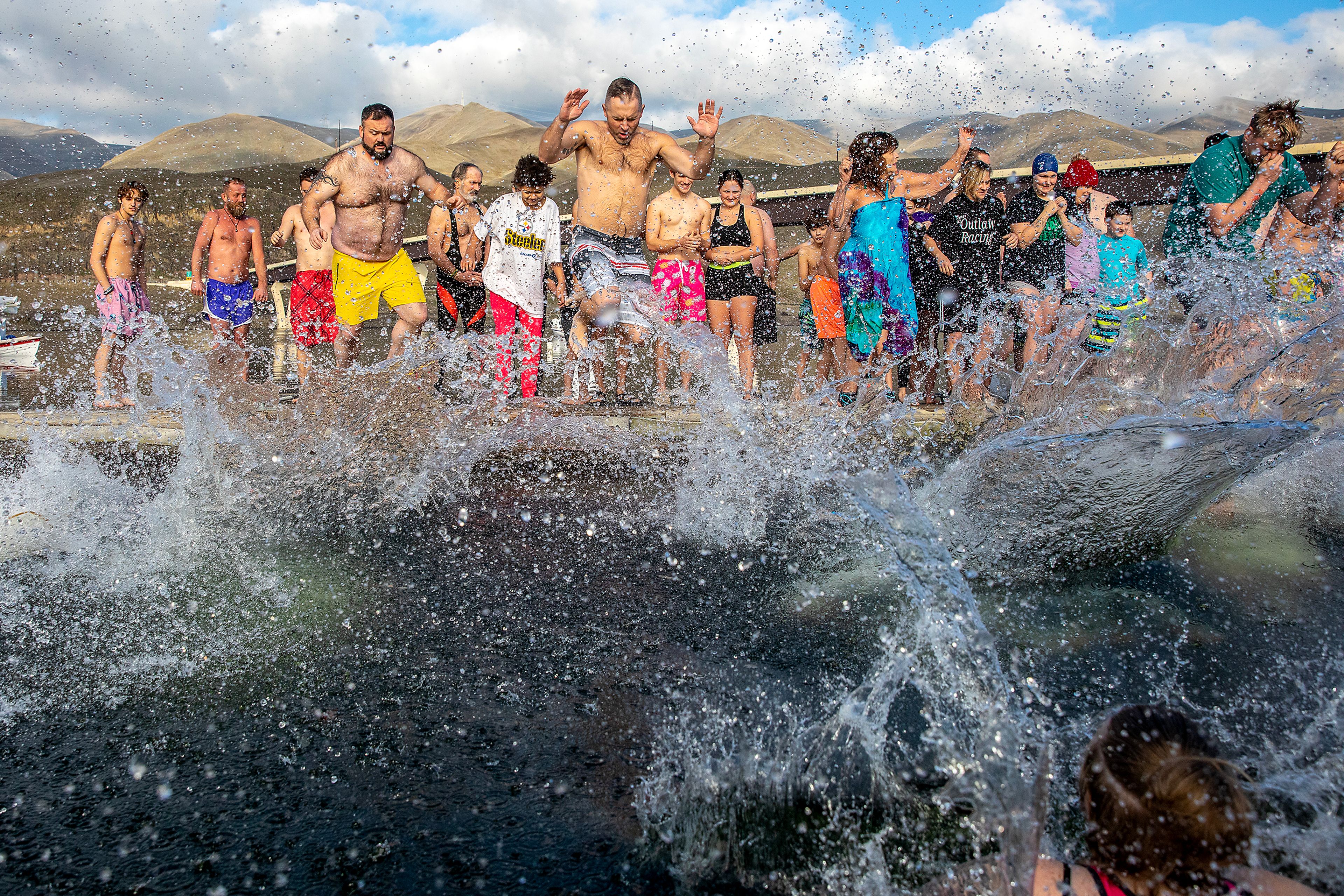 Water splashes up as people take the jump into the Snake River for the annual Polar Plunge Monday in Clarkston.