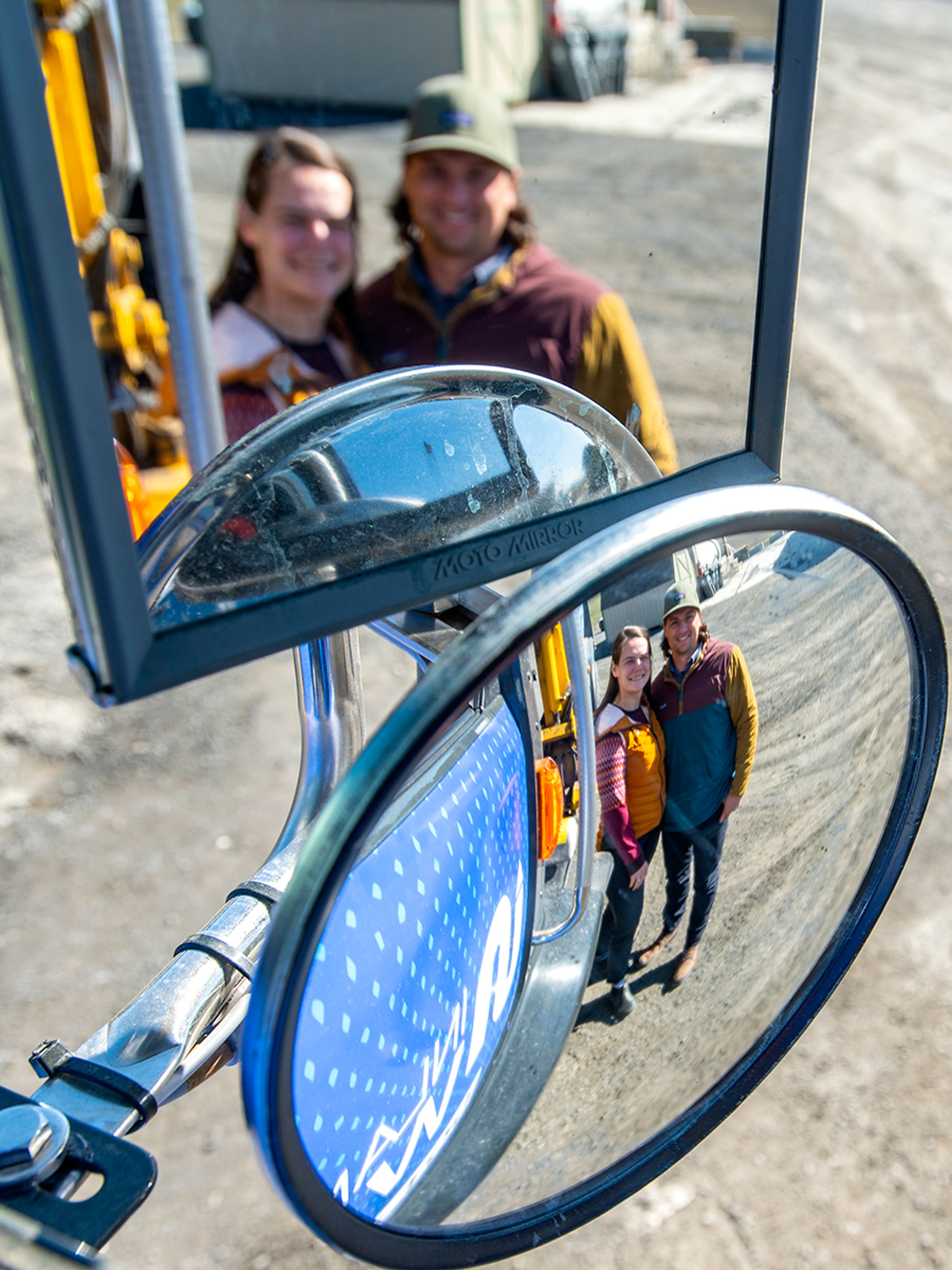 The images of Inland North Waste’s Chief Administrative Officer Stevie Steely-Johnson and her husband, CEO Brandon Steely-Johnson, are reflected in mirrors of one of the company’s trucks.