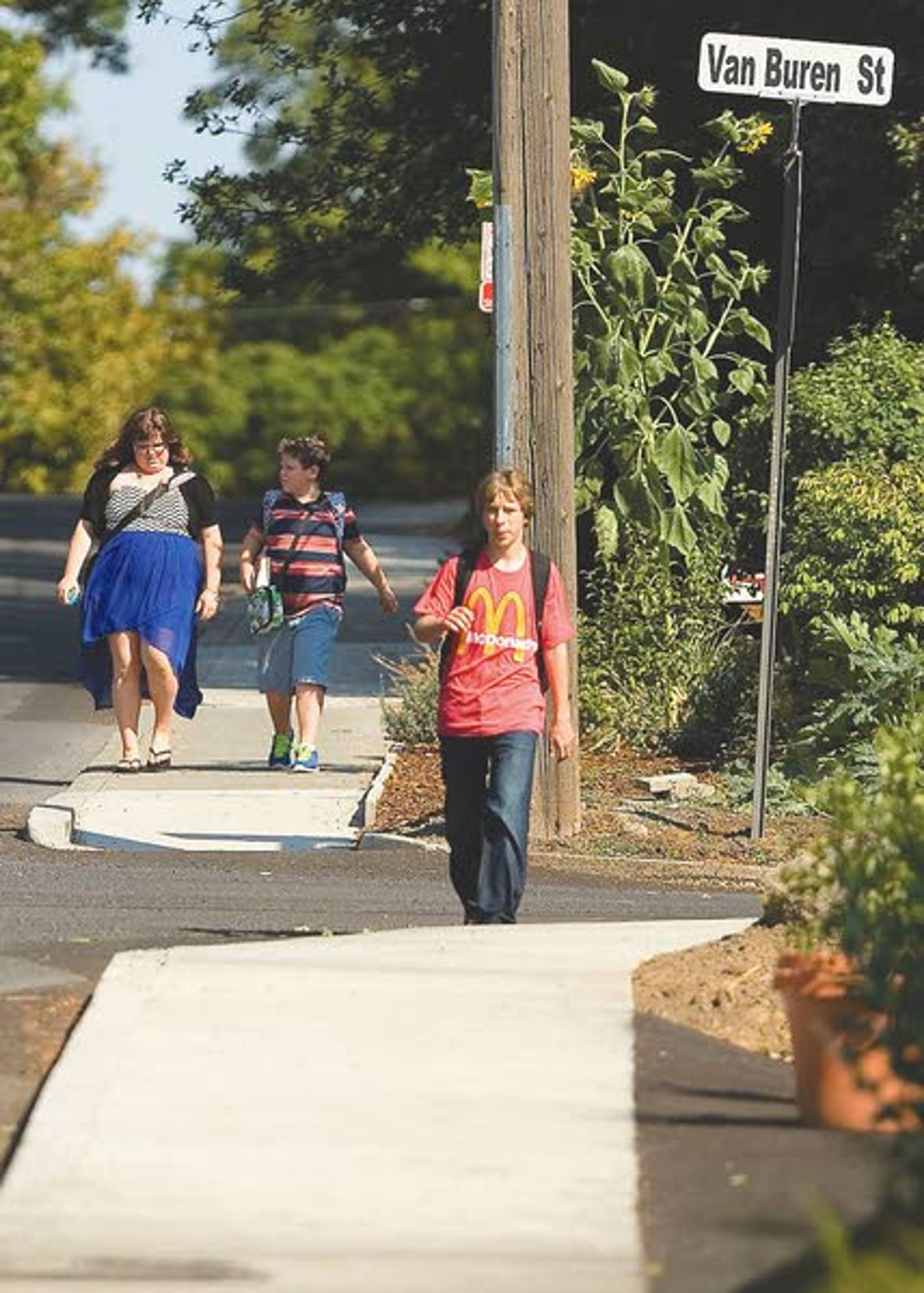 Children walk after school Wednesday on a new sidewalk on east D Street in Moscow.