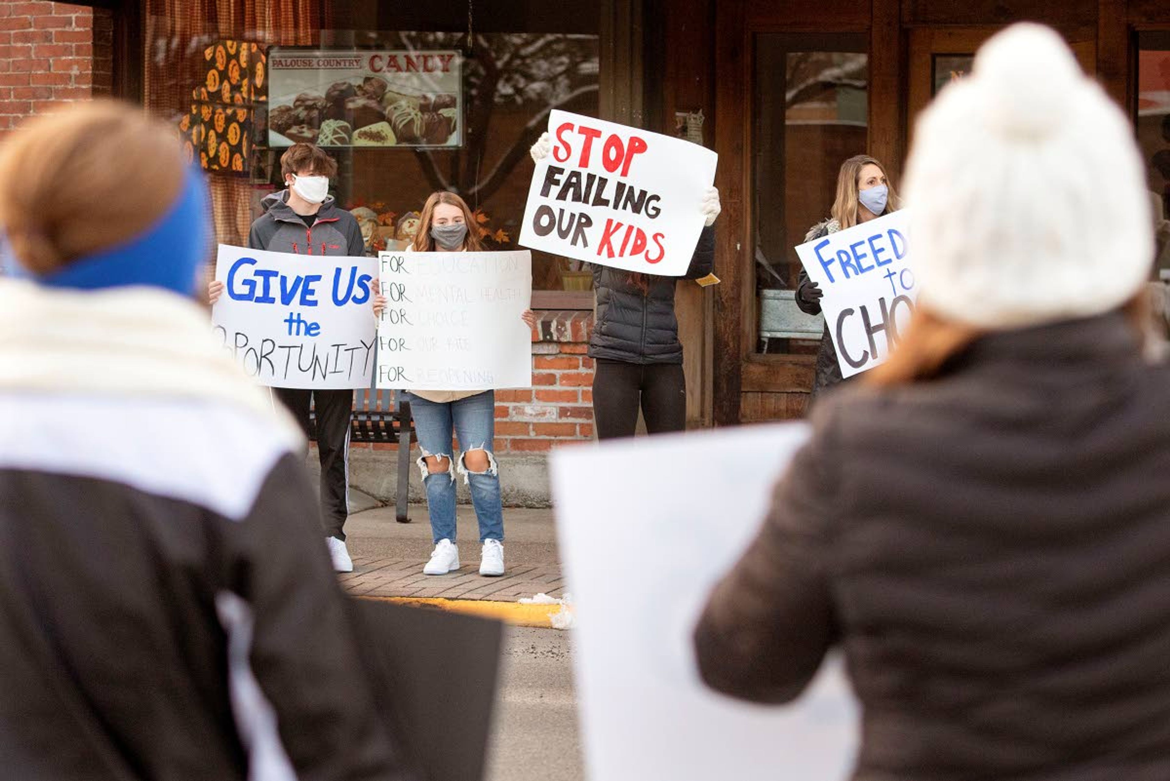 Demonstrators urge the school board to transition to in-person classes as soon as possible during a demonstration Monday in Pullman.