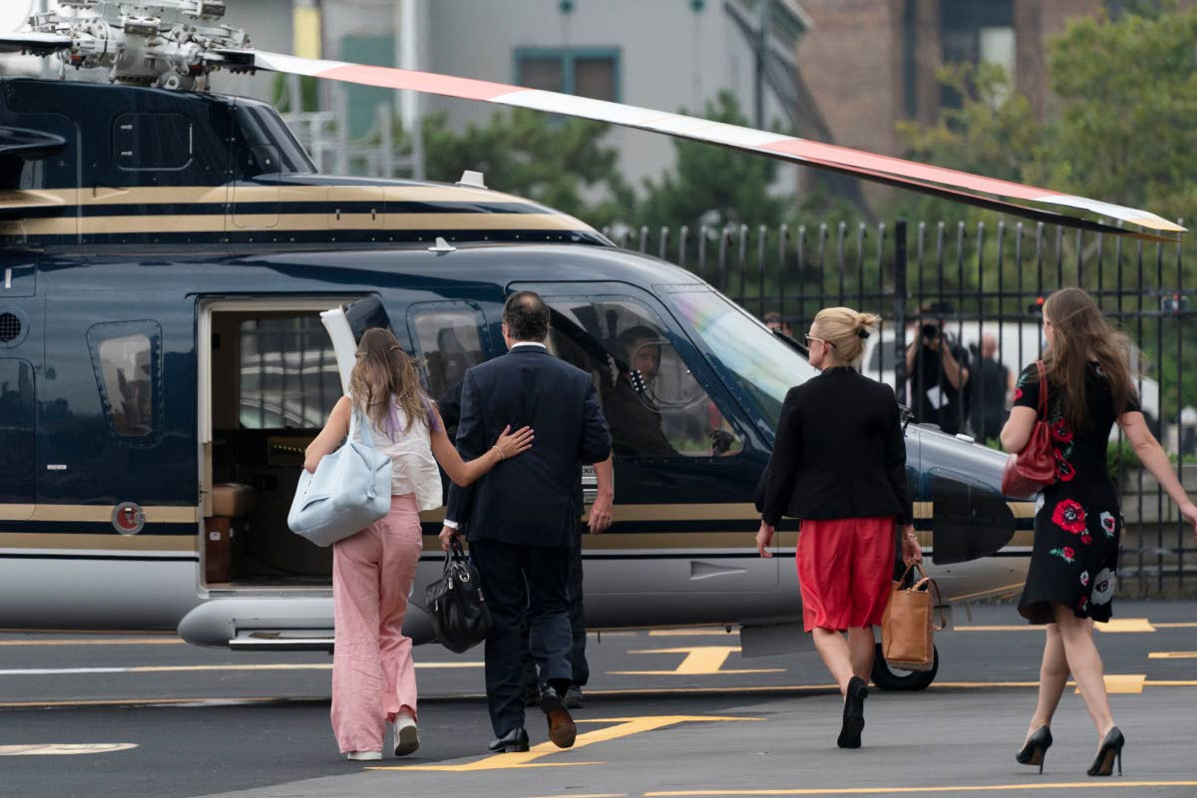 New York Gov. Andrew Cuomo and others walk towards a helicopter at a Manhattan heliport in New York on Tuesday, Aug. 10, 2021. Cuomo says he will resign over a barrage of sexual harassment allegations. The three-term Democratic governor’s decision, which will take effect in two weeks, was announced Tuesday as momentum built in the Legislature to remove him by impeachment. (AP Photo/Mark Lennihan)