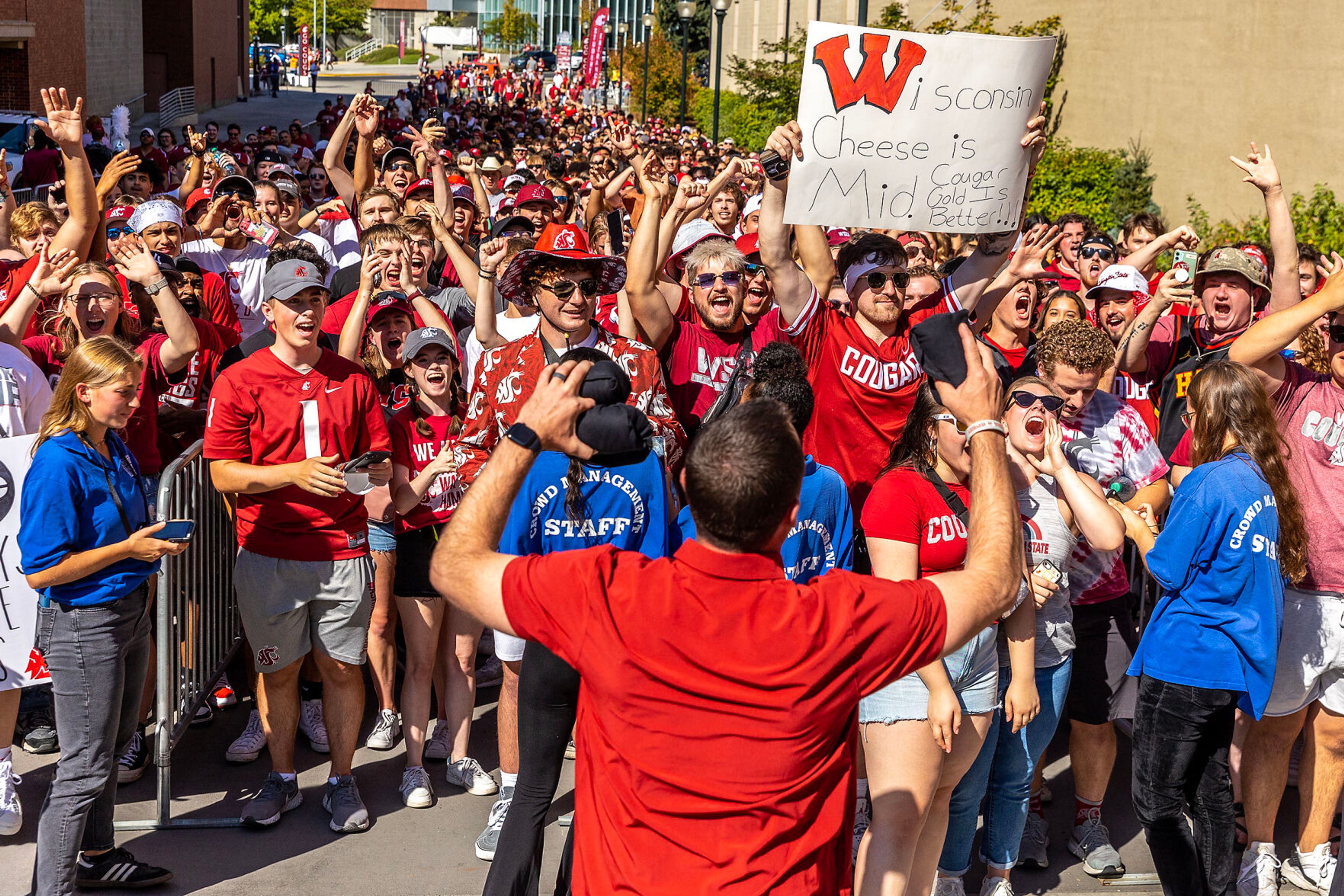 Cougar fans cheer as Head Coach Jake Dickert arrives during a nonconference game against Wisconsins Saturday in Pullman.