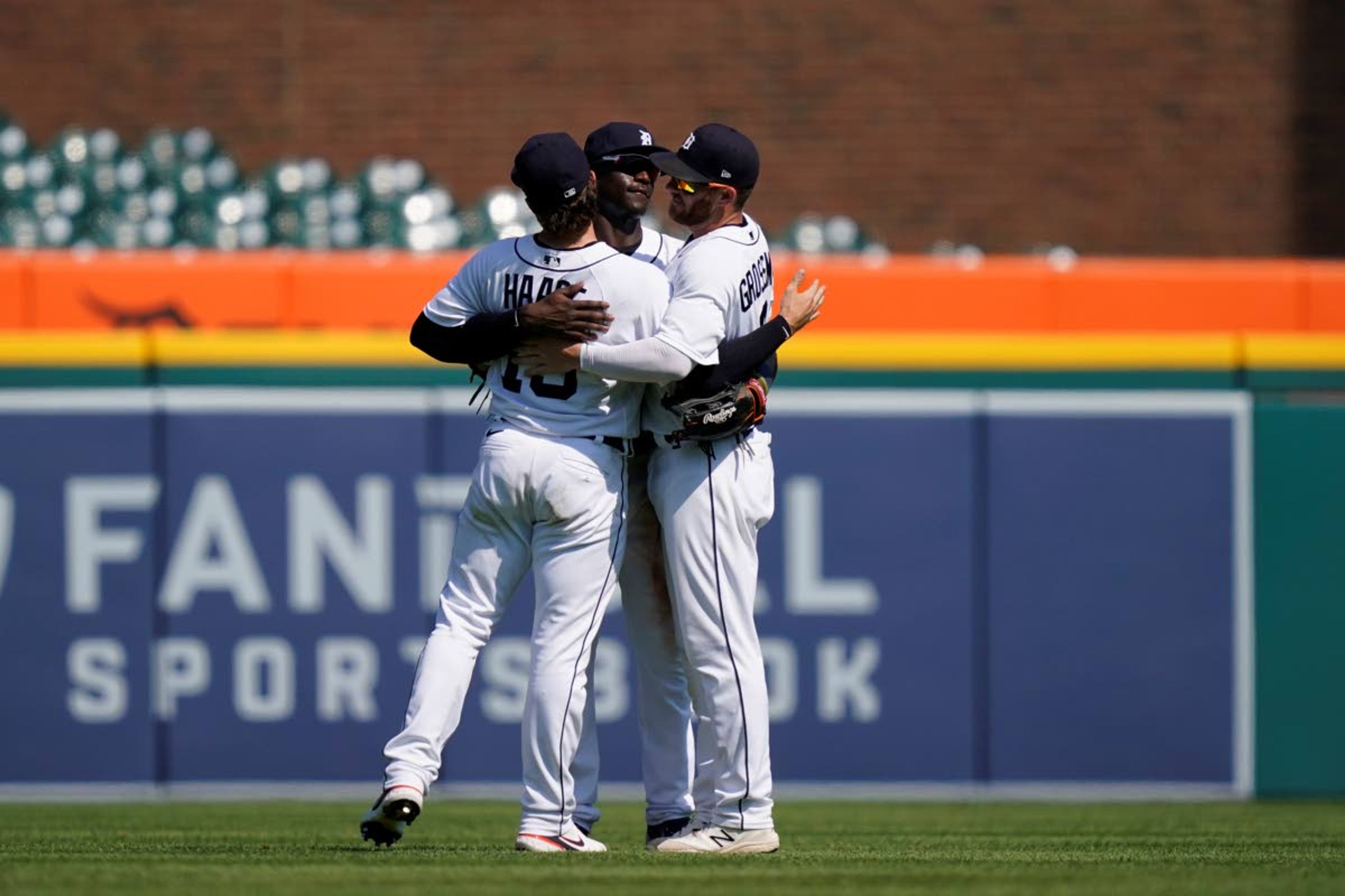 From left, Detroit Tigers left fielder Eric Haase (13), center fielder Daz Cameron (41) and right fielder Robbie Grossman (8) celebrate the Tigers' 8-3 win over the Seattle Mariners in a baseball game, Thursday, June 10, 2021, in Detroit. (AP Photo/Carlos Osorio)