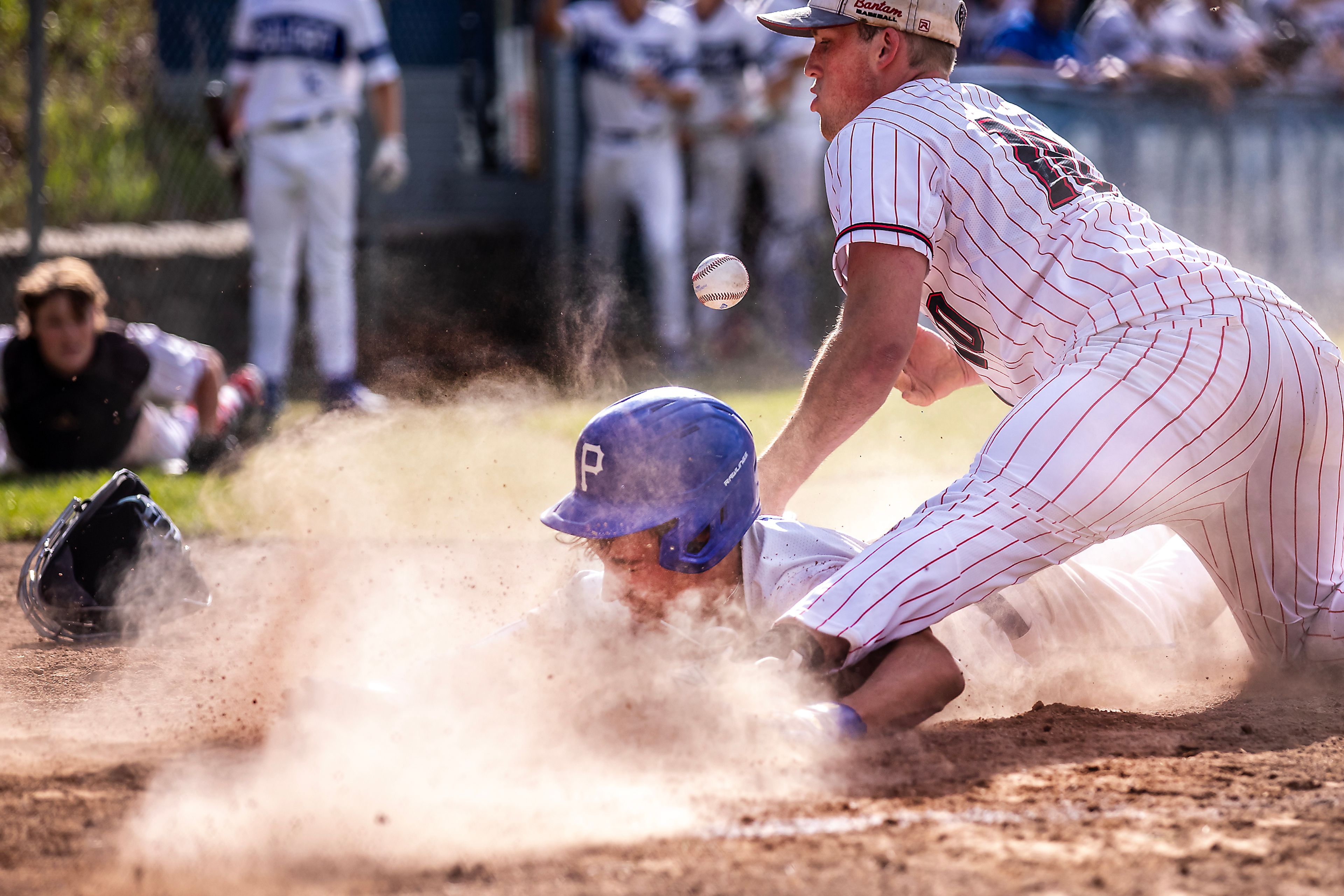 Pullman’s Brayden Randall slides into home to score as Clarkston pitcher Trace Green attempts to tag him out during a semifinal game of the district tournament Thursday in Pullman.