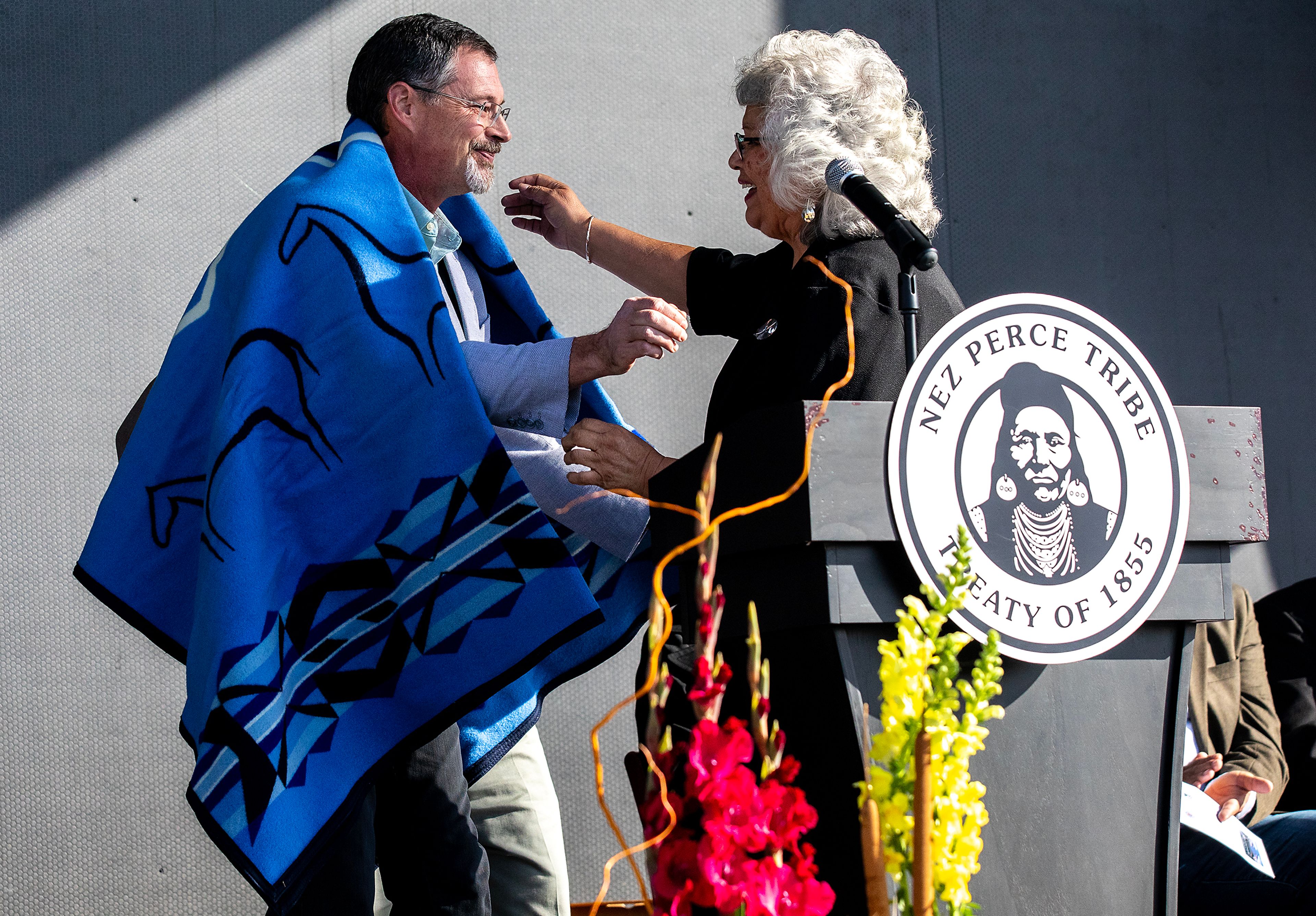 John Watson, J-U-B Engineers project manager, hugs Mary Beth Clark after receiving a blanket Thursday for his work on the Aht�Wy Interchange at the ribbon cutting ceremony over U.S. Highway 95/12 in Lewiston.