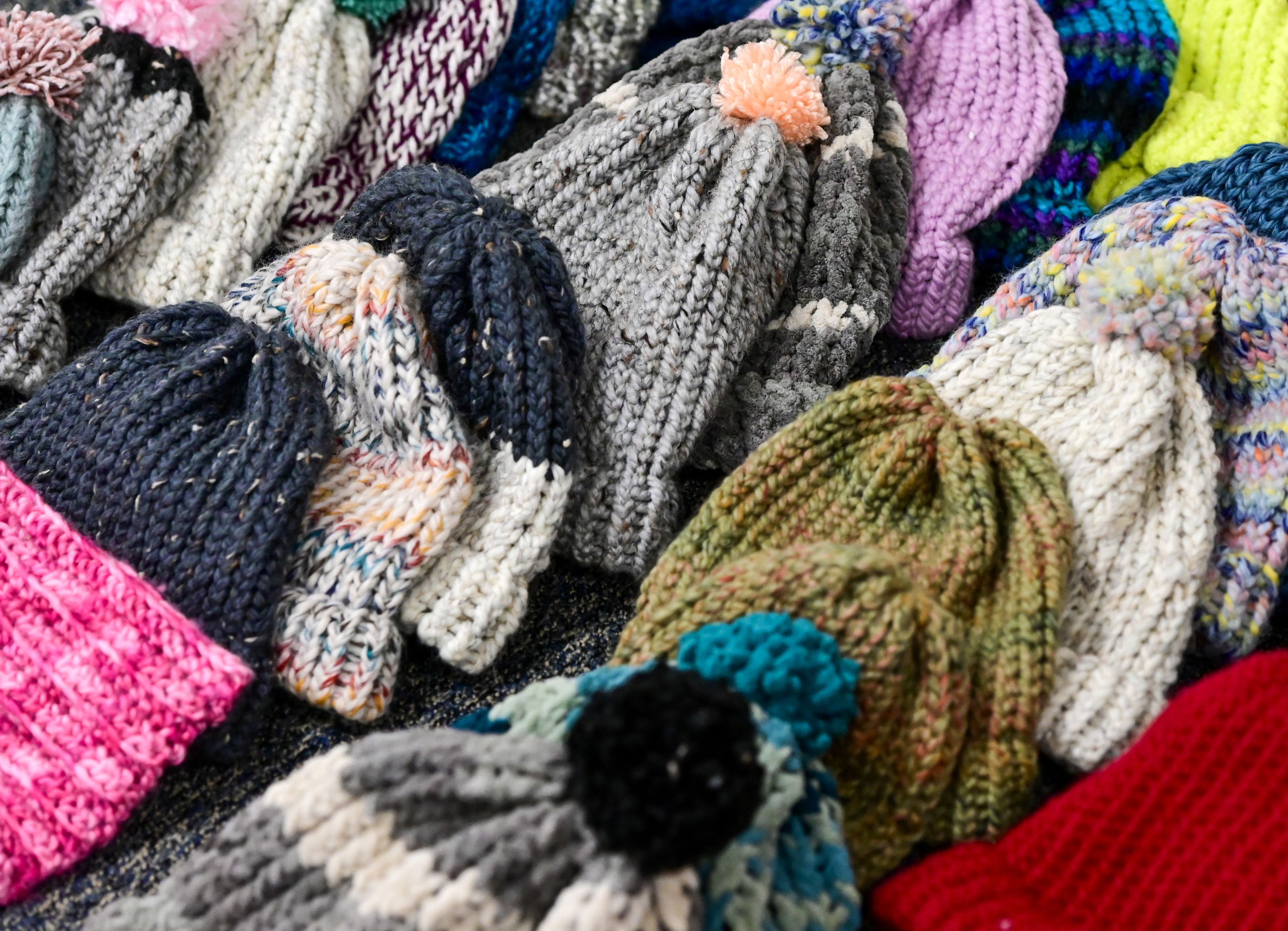 Hats made by Lena Whitmore Elementary School’s knitting club are laid out in the classroom of fourth grade teacher Lindsey Lee at the school in Moscow on Monday.