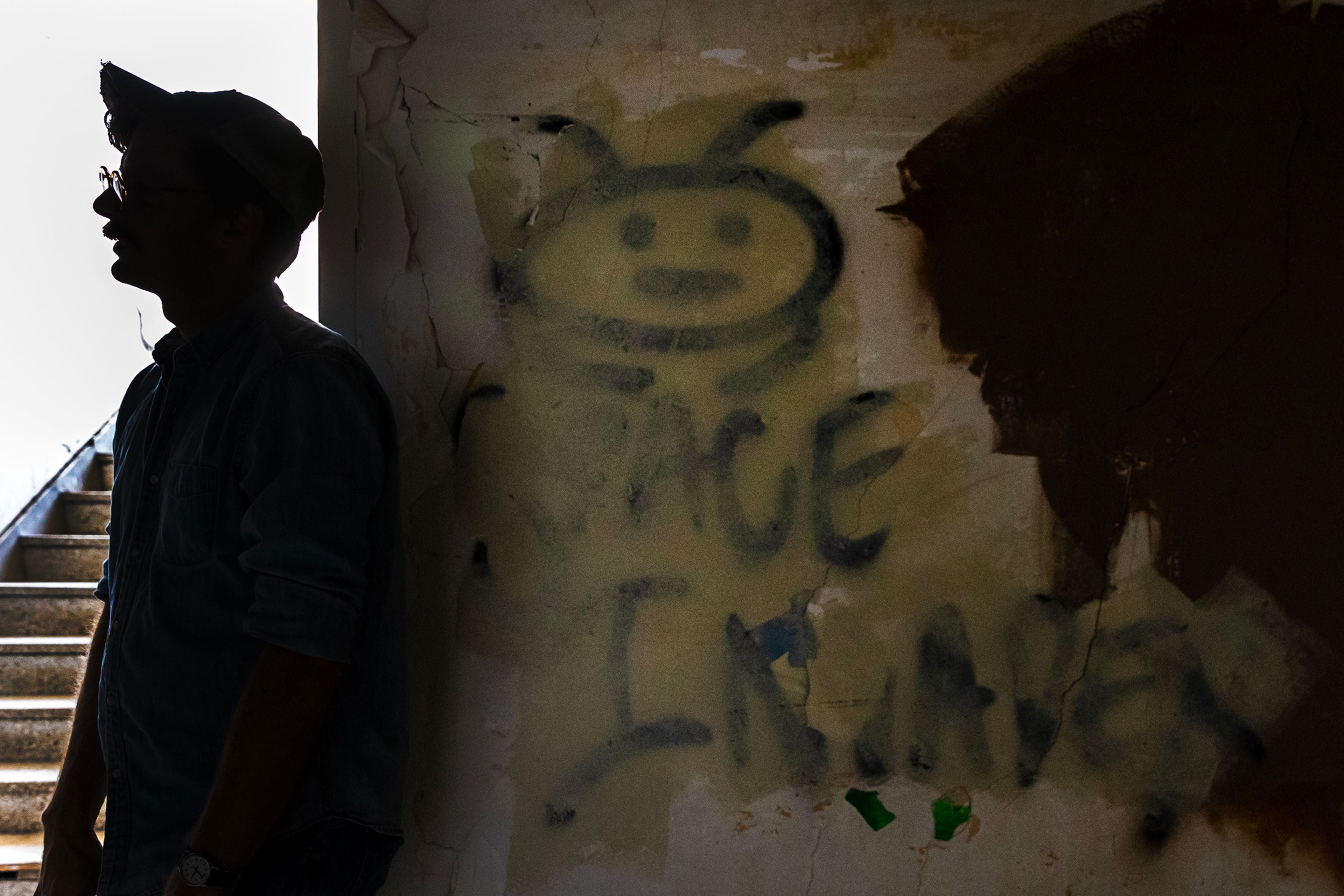 Austin Storm leans against a wall where "space invader" is written at St. Ignatius Hospital in Colfax.