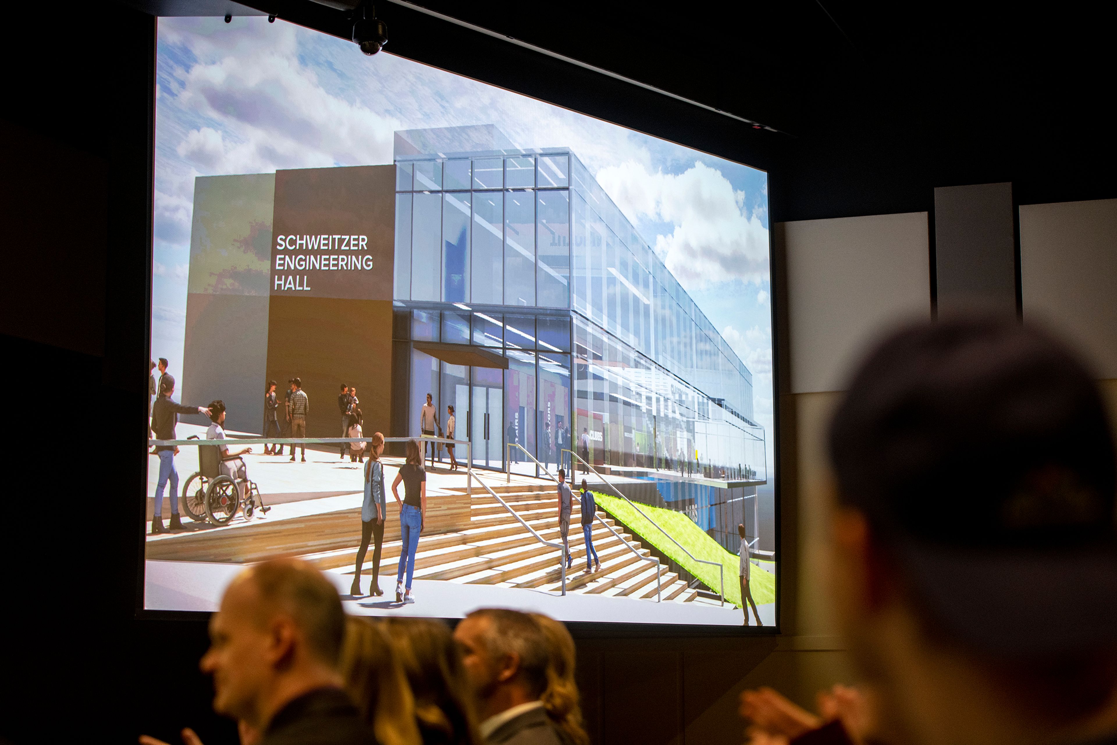 Audience members applaud as they see conceptual renderings of Schweitzer Engineering Hall on Washington State University’s campus.