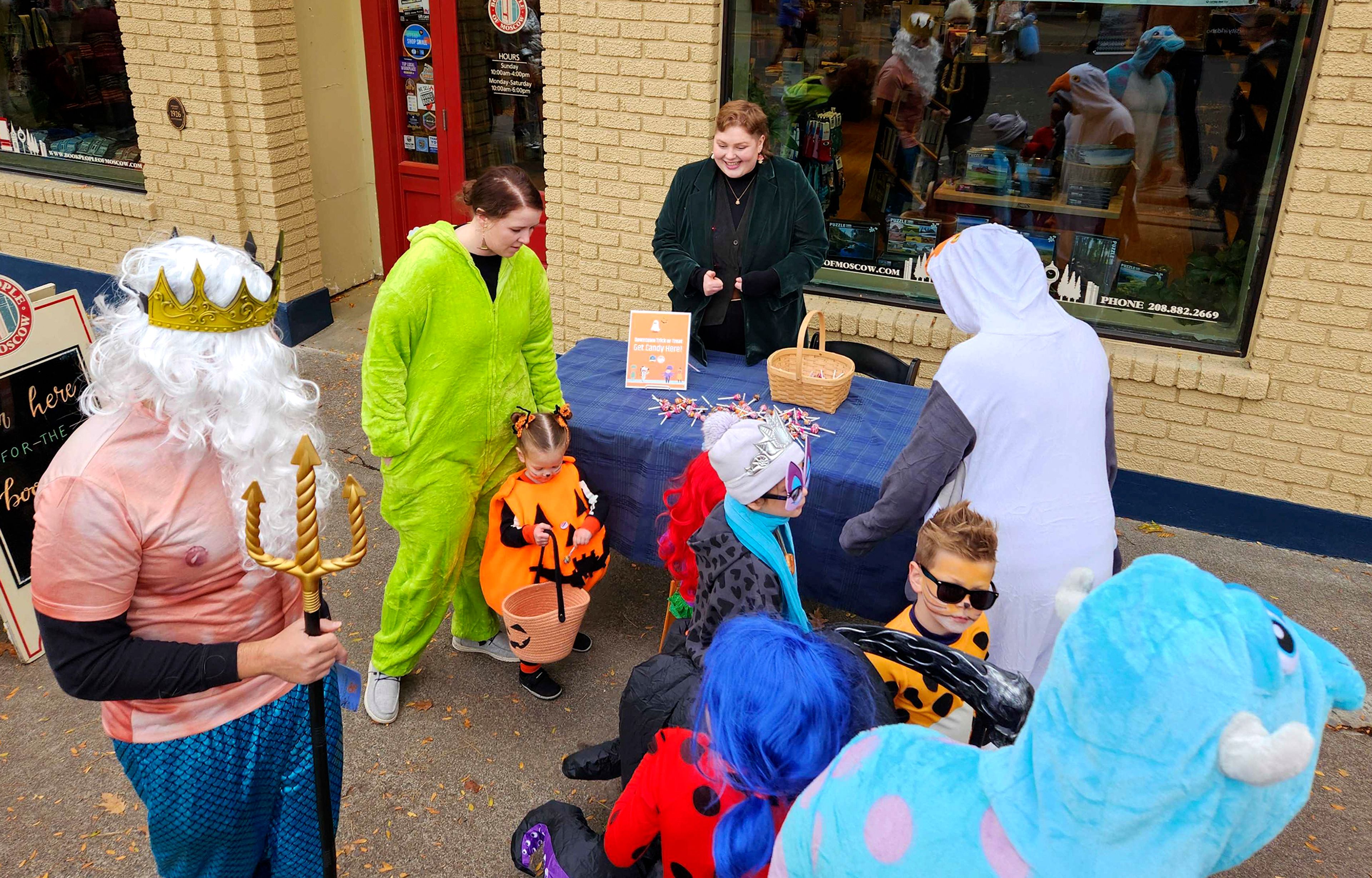 BookPeople of Moscow co-owner Bre Pickens hands out candy Thursday in downtown Moscow.,