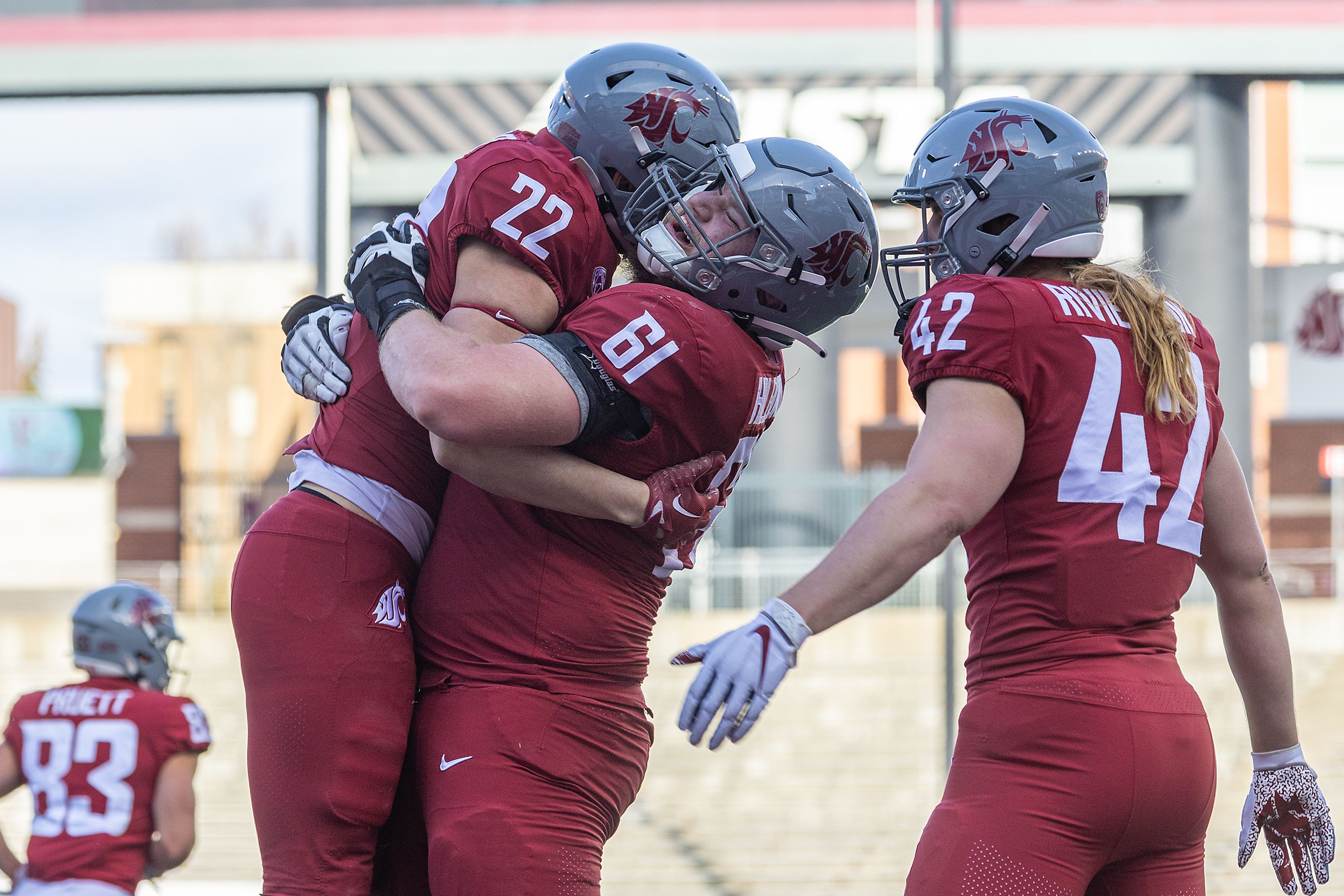 Washington State defensive back Warren Smith (22) is hugged by lineman Christian Hilborn after Smith stopped the offensive from scoring during the annual Crimson and Gray scrimmage game at Gesa Field in Pullman.