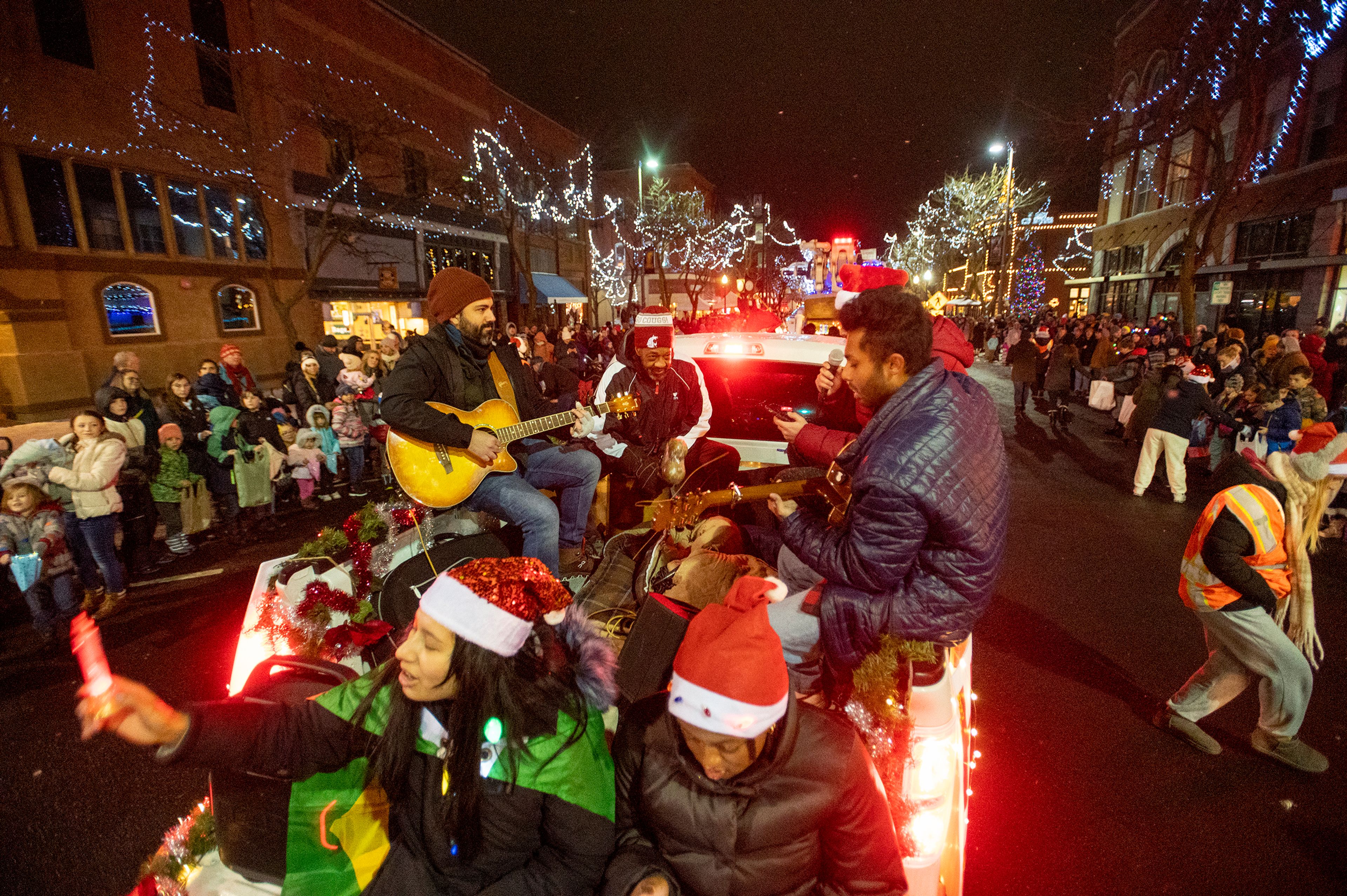 Participants sing Christmas songs during the Light up the Season Parade in downtown Moscow on Thursday.