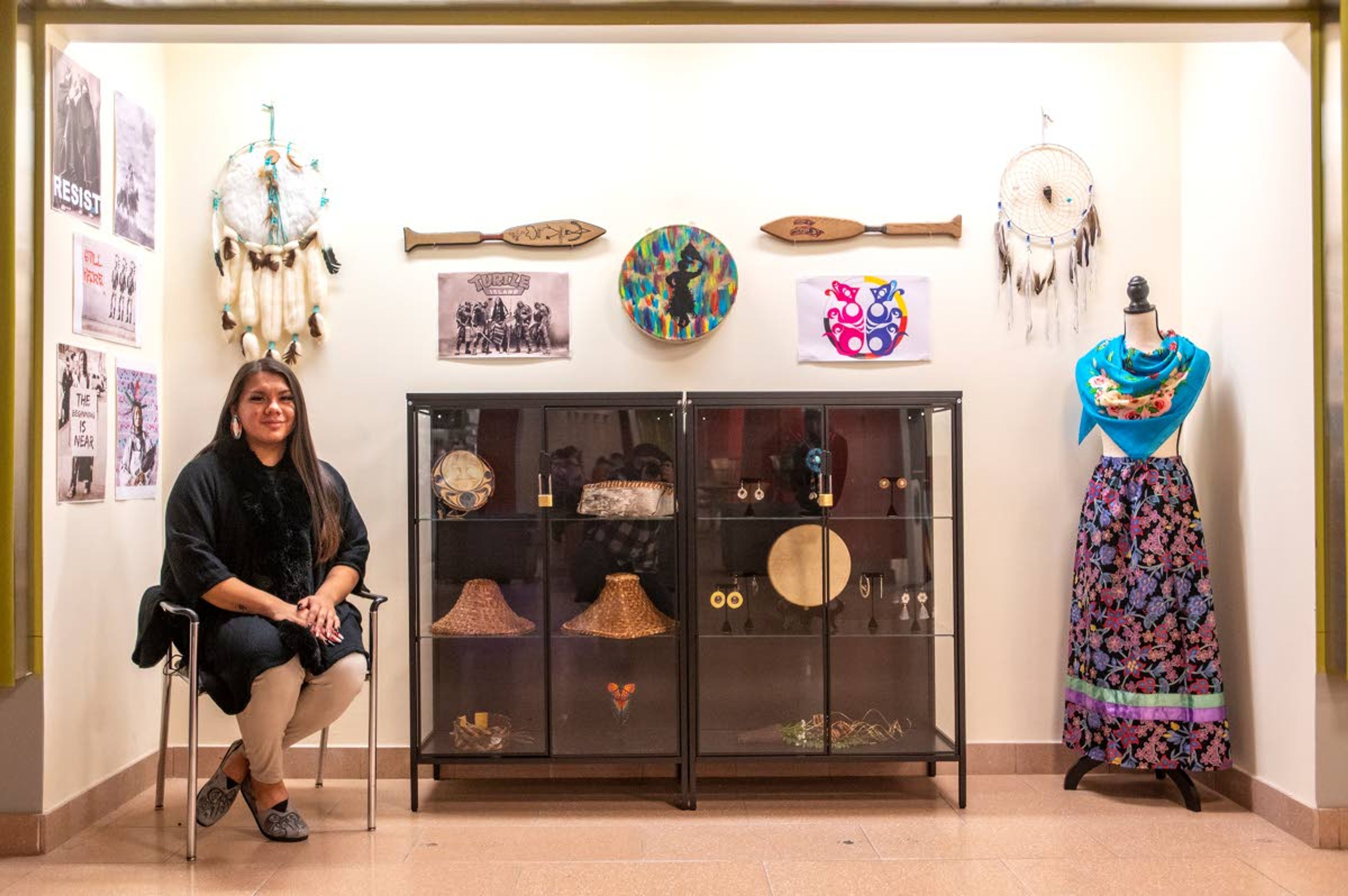 Artist Fabian Sanchez Mondejar poses for a portrait in front of an art exhibit in the lower level of the Compton Union Building on Washington State University’s campus. Mandejar’s exhibit highlights Native American culture including work from the Muckleshoot Indian Tribe. ,