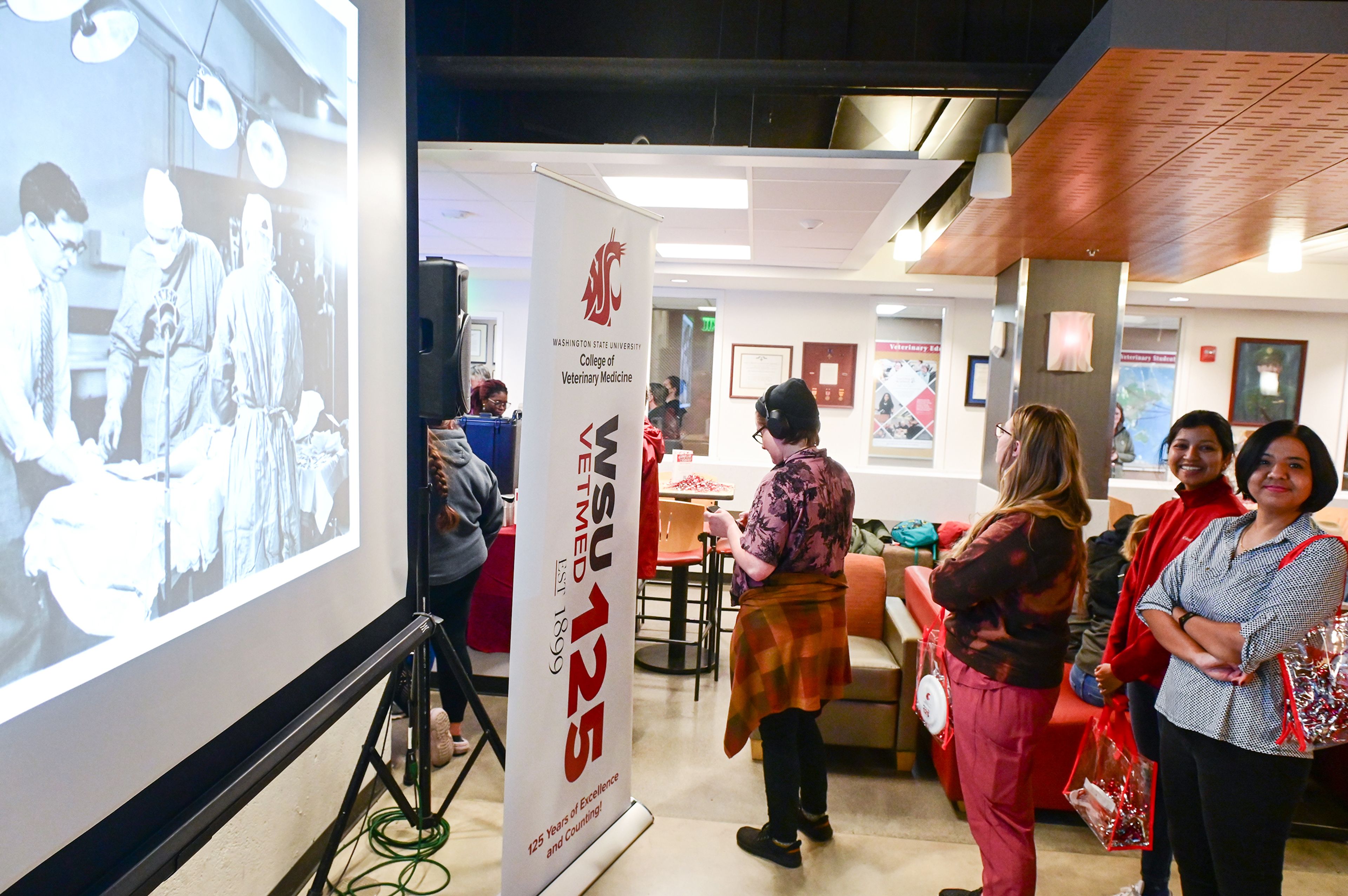 A slideshow of photos from the 125 years of the Washington State University College of Veterinary Medicine runs at a celebration event for the school Friday in Pullman.,