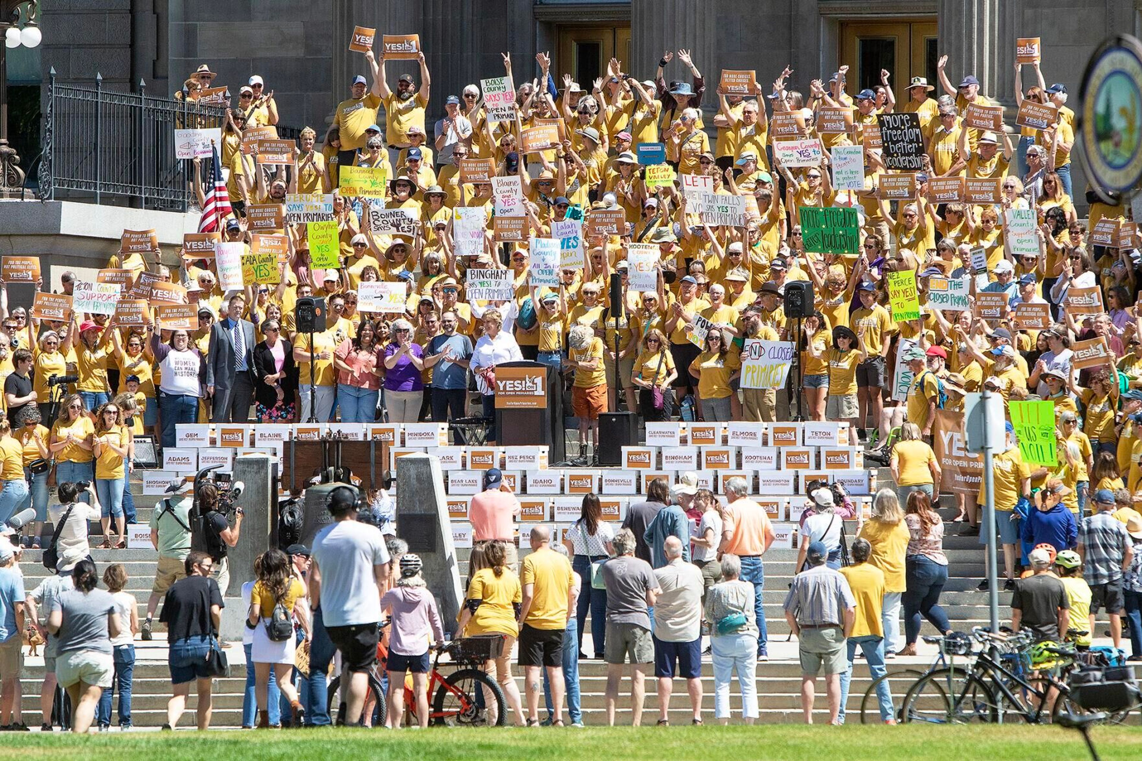 Supporters of open primaries for Idaho gather on the steps of the state Capitol building with boxes of signatures to be delivered to the Secretary of State’s office on July 2 in Boise.