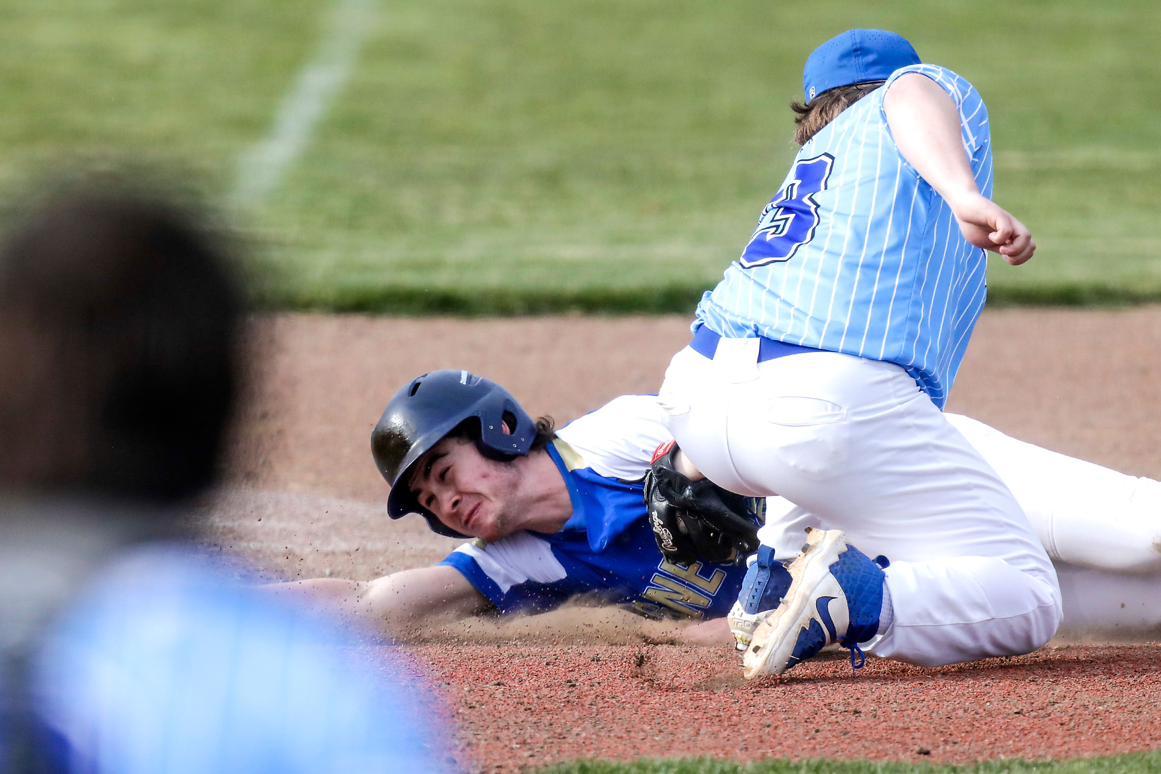 Genesee Jackson Zenner reaches for third base as Colton third baseman Jaxon Moehrle looks to tag him out in Genesee on Monday.