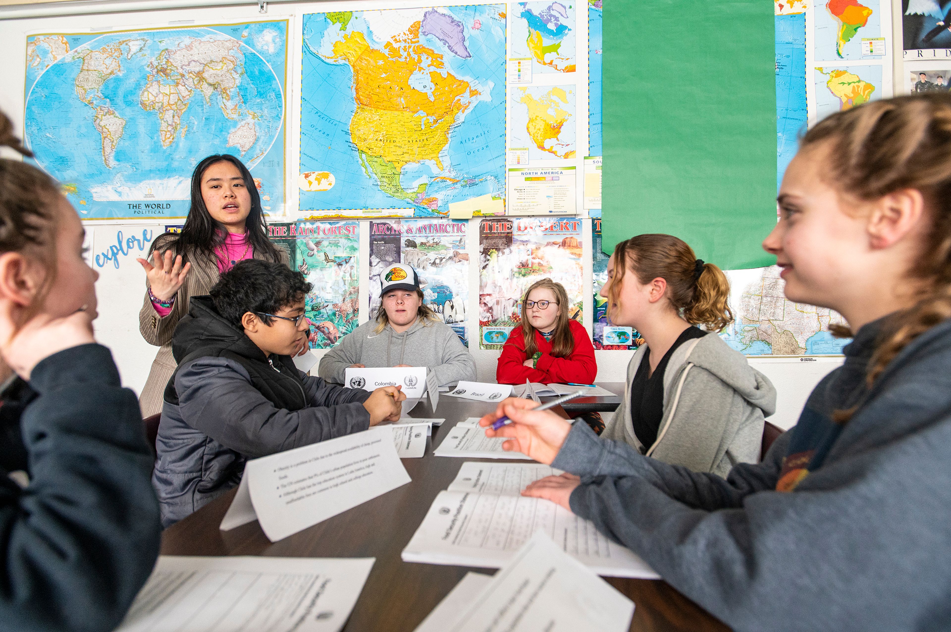 Moscow High School student Nicole Xiao, top left, works with Moscow Middle School students during a Model UN event Wednesday afternoon.