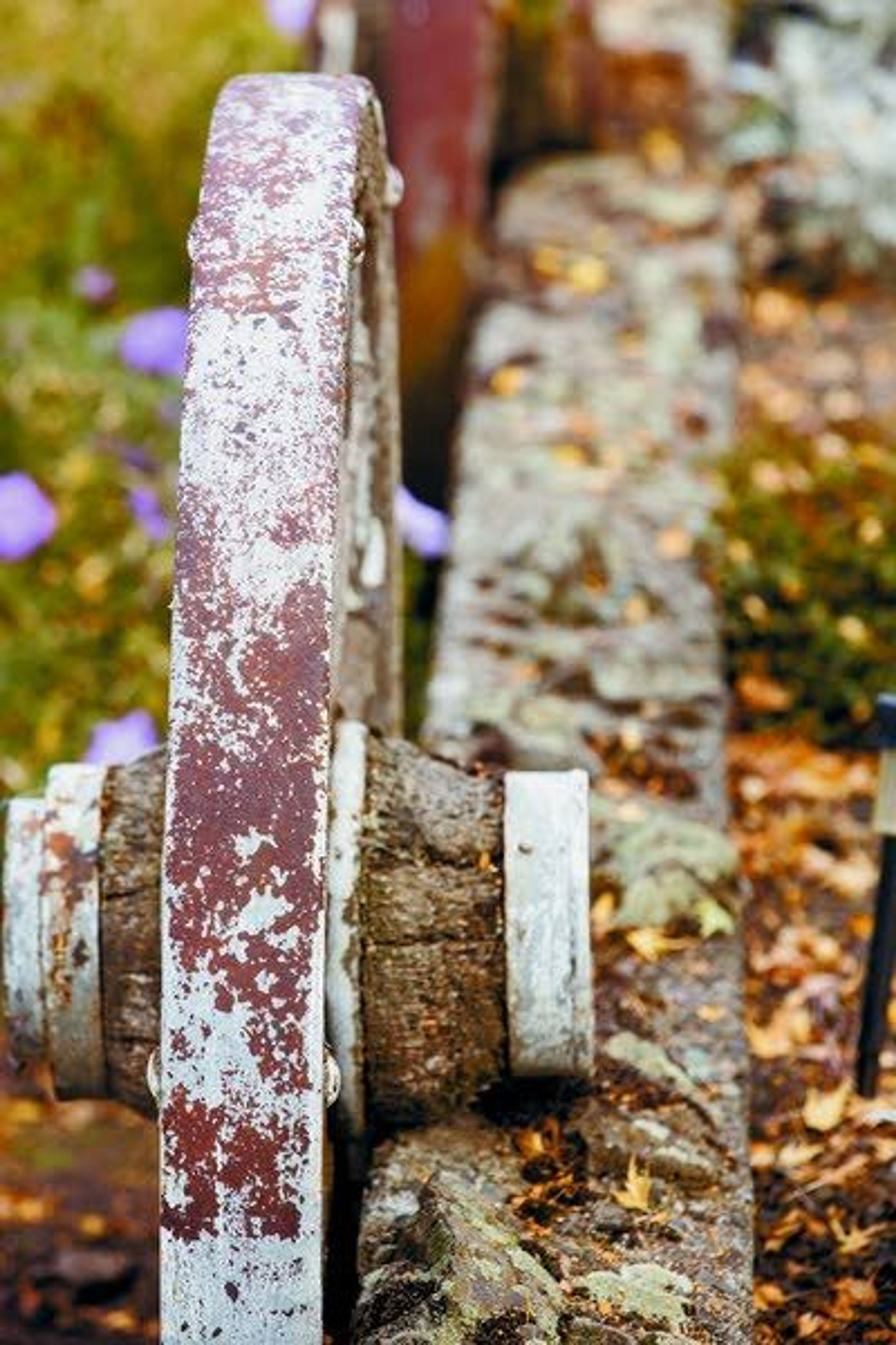 An old wooden wagon wheel is used as a retaining wall decoration.