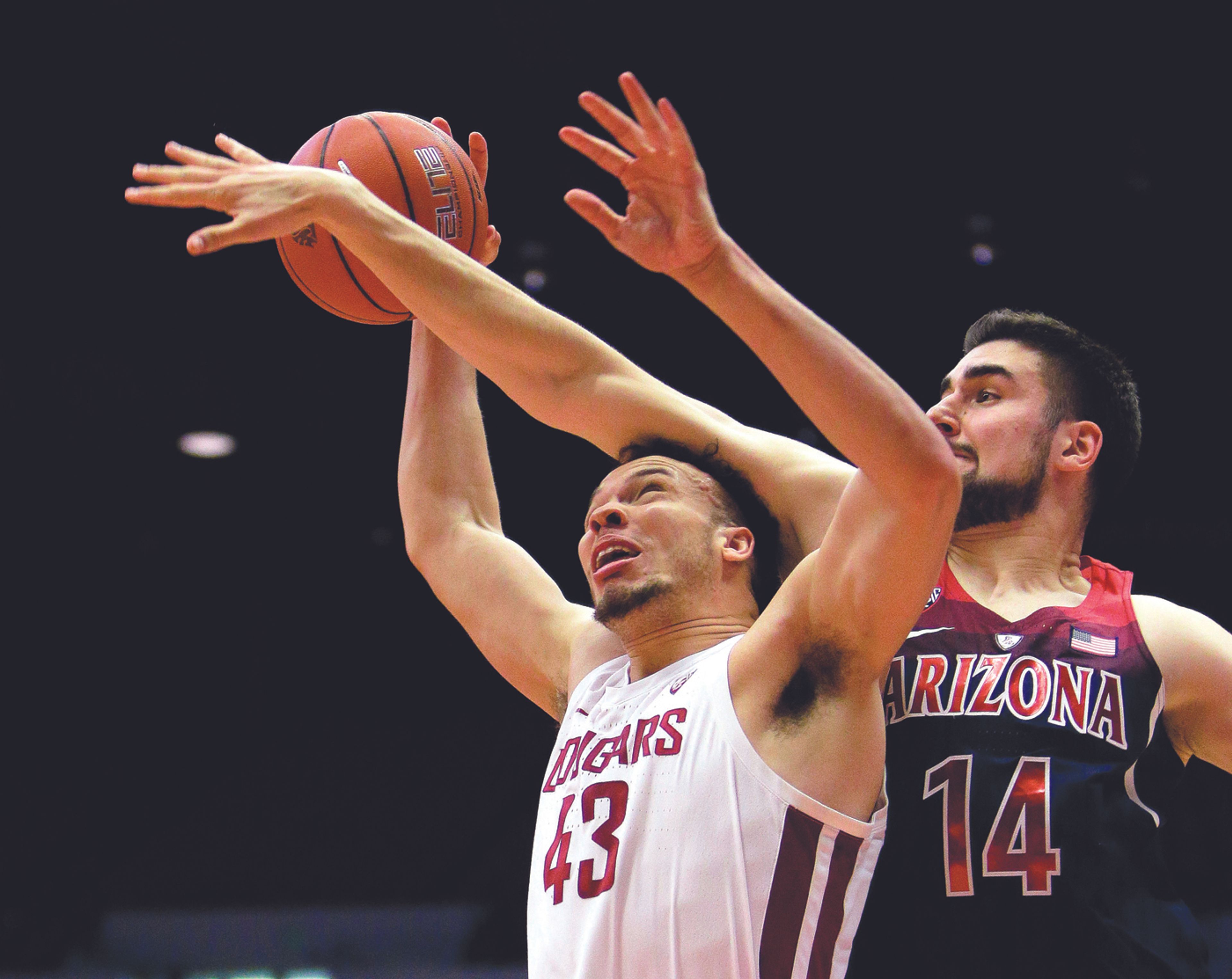 Washington State forward Drick Bernstine (43) is fouled on the way to the basket by Arizona center Dusan Ristic (14) during the first half Wednesday in Pullman.