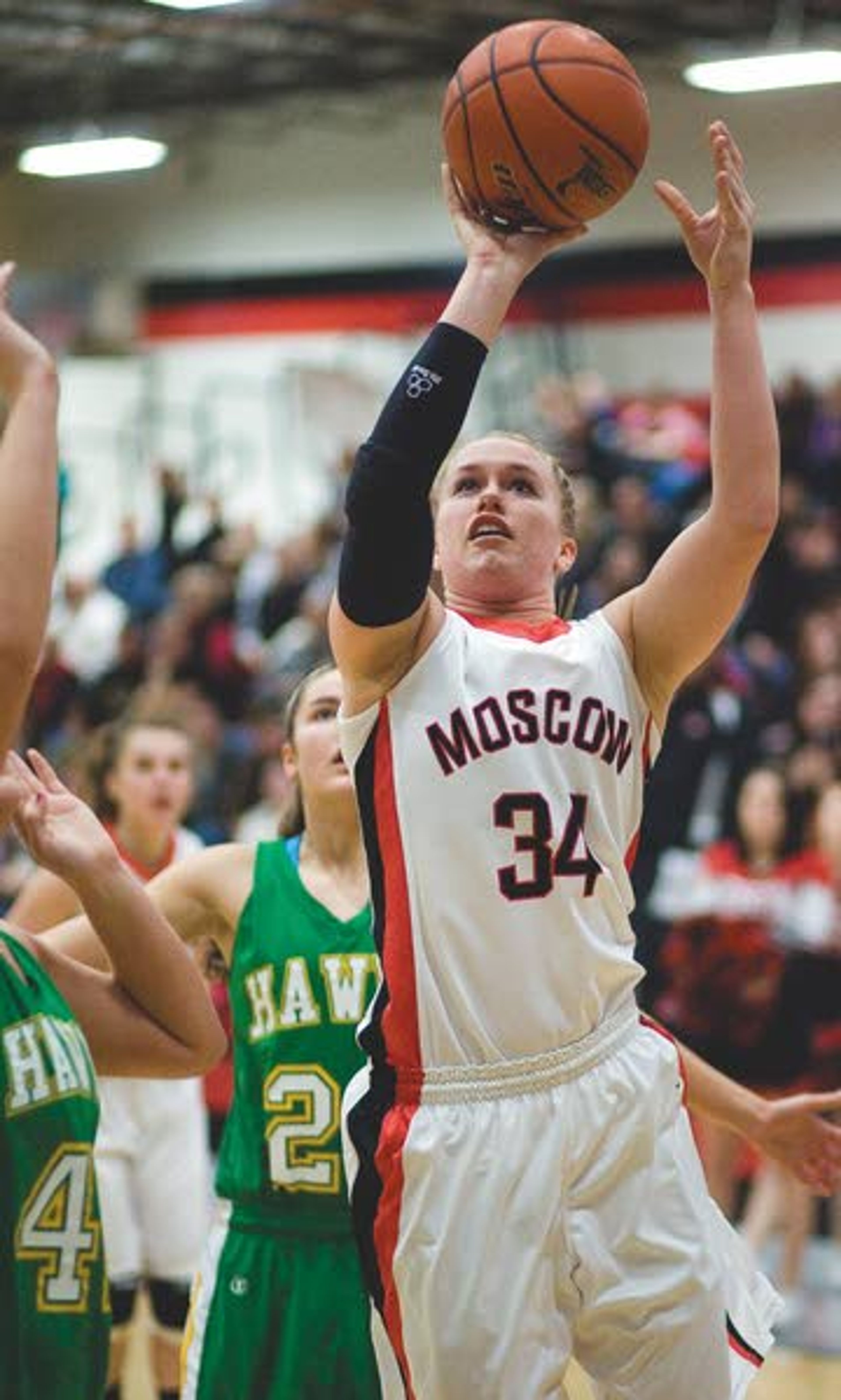 Moscow post Taylor Anderson (34) scores over Lakeland’s Kacie
Derby, left, as Jordan Ward (20) watches during the first half of a
high school district playoff game on Tuesday at Bear Den in
Moscow.