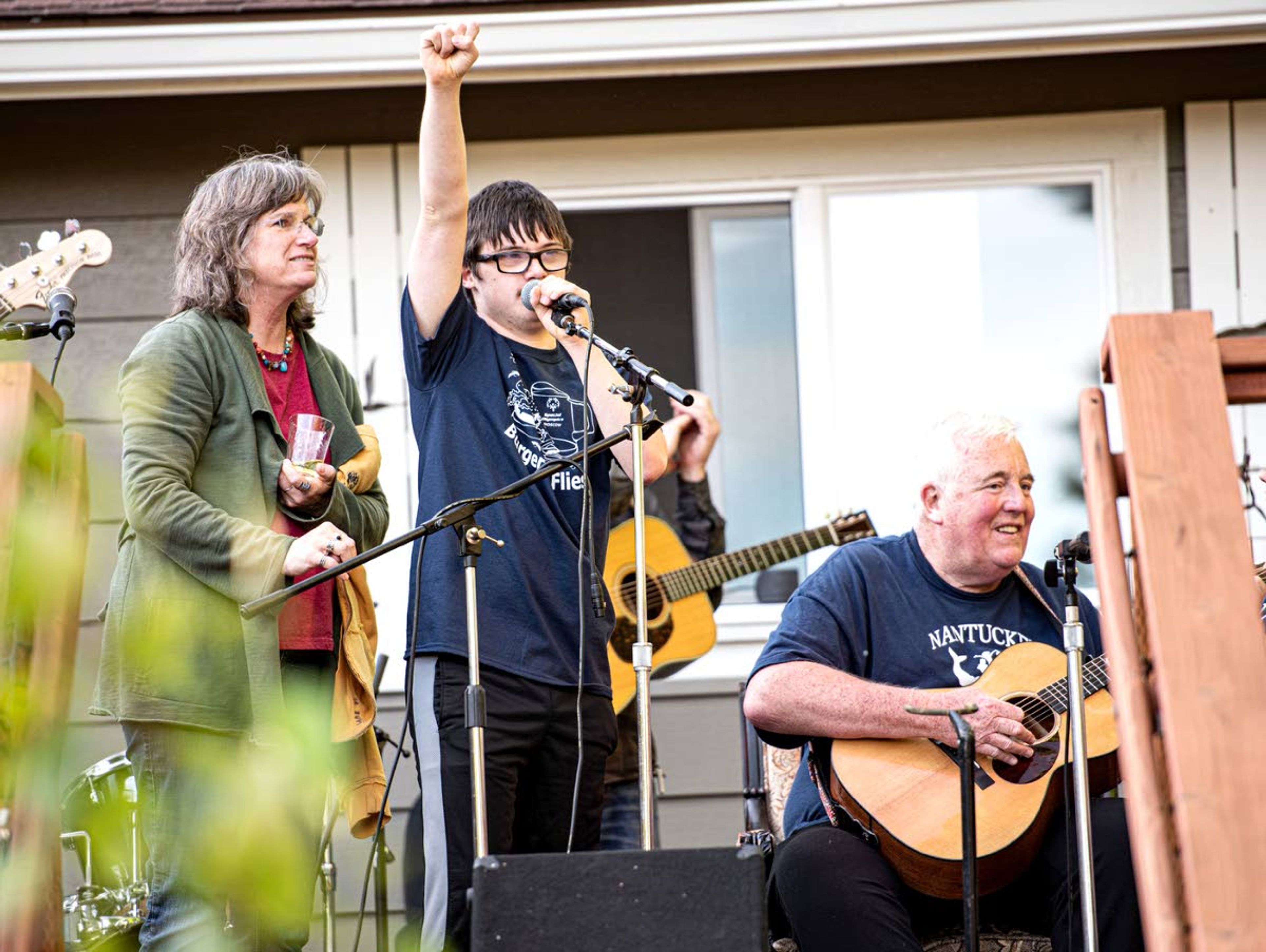 Courtesy Joe McGurkinJoe McGurkin, right, is joined on “stage” by Lorie Higgins, left, and Gabe Vollmer during the 2019 Burgers and Flies backyard party and auction in Moscow.