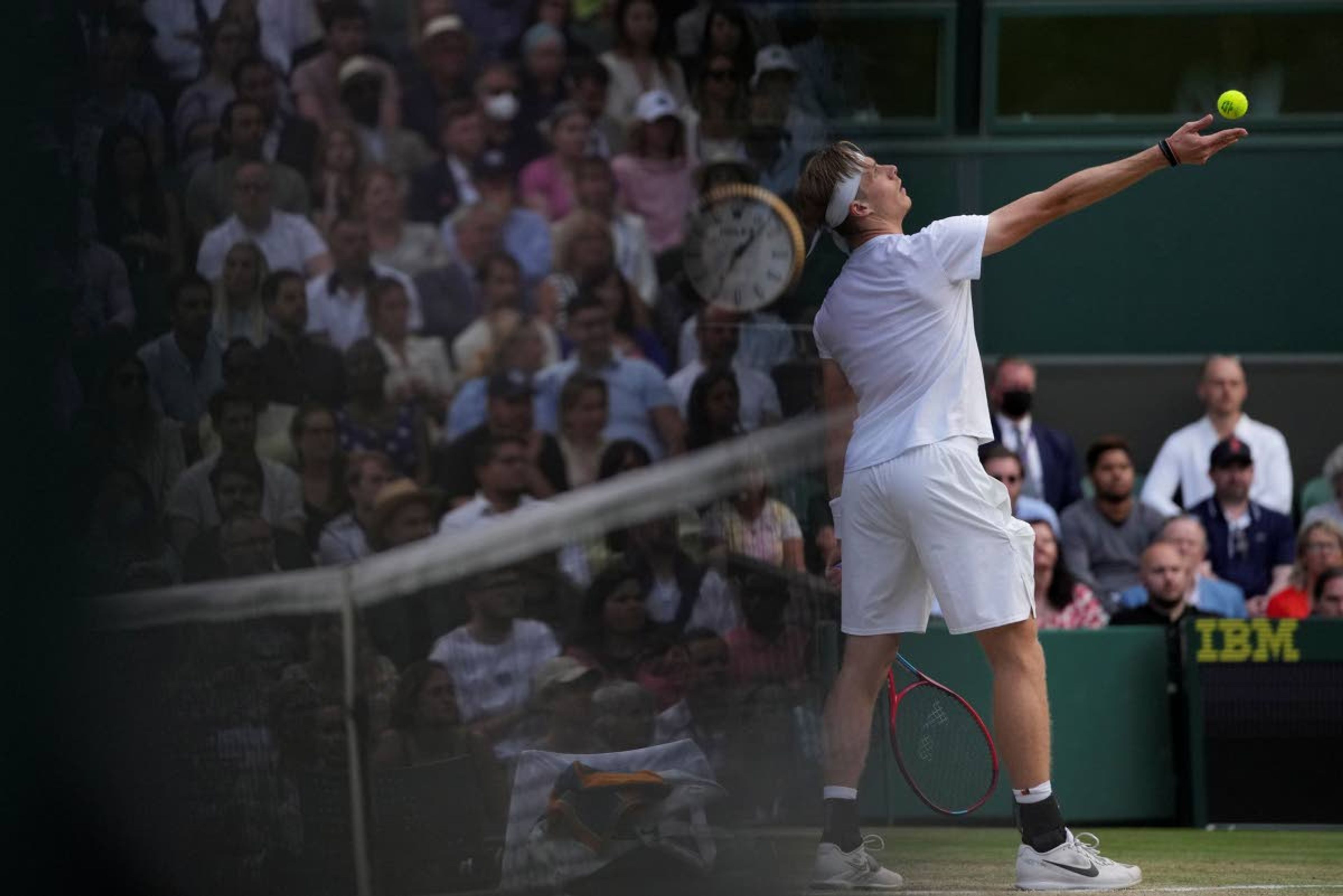 Canada's Denis Shapovalov serves to Serbia's Novak Djokovic during the men's singles semifinals match on day eleven of the Wimbledon Tennis Championships in London, Friday, July 9, 2021. (AP Photo/Alberto Pezzali)